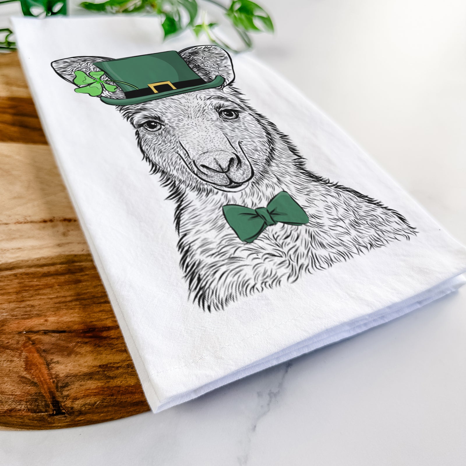 Hand-drawn sketch of Evelyn the Eastern Grey Kangaroo wearing a St. Patrick's Day leprechaun hat and bow tie on a tea towel