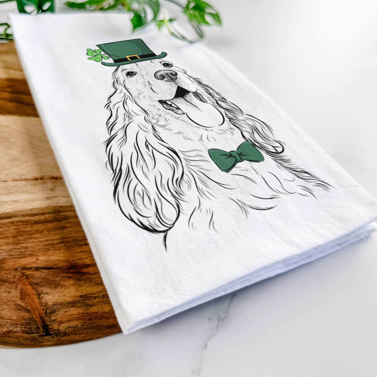 Hand-drawn sketch of Happy Henry the English Cocker Spaniel wearing a St. Patrick's Day leprechaun hat and bow tie on a tea towel