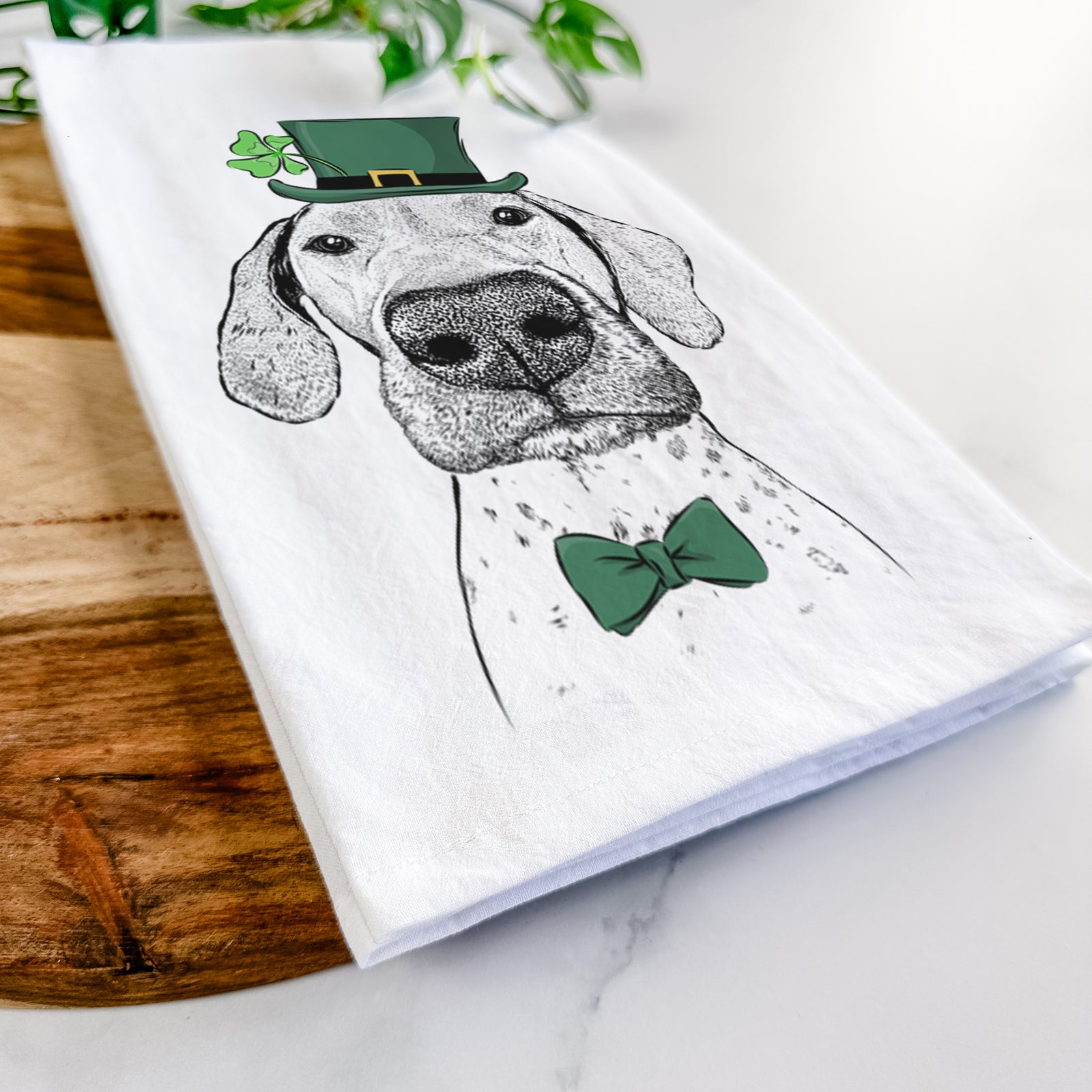 Hand-drawn sketch of Leroy the German Shorthaired Pointer wearing a St. Patrick's Day leprechaun hat and bow tie on a tea towel