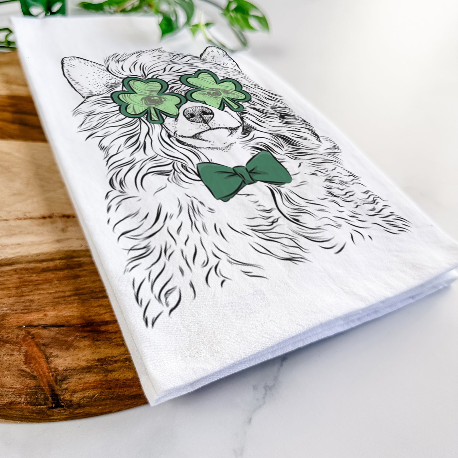 Hand-drawn sketch of Preston the Powderpuff Chinese Crested wearing a St. Patrick's Day leprechaun hat and bow tie on a tea towel