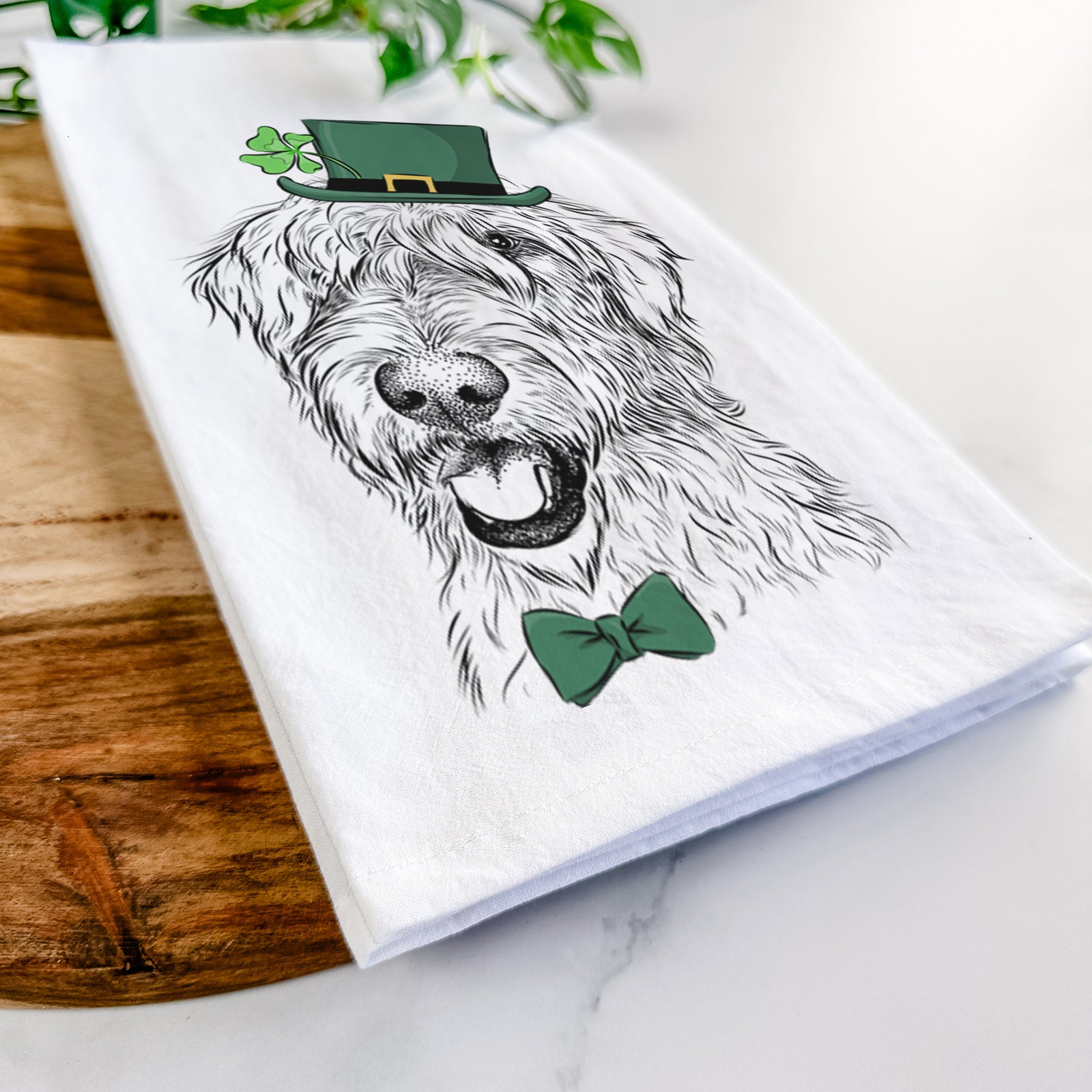 Hand-drawn sketch of Ragnar the Irish Wolfhound wearing a St. Patrick's Day leprechaun hat and bow tie on a tea towel