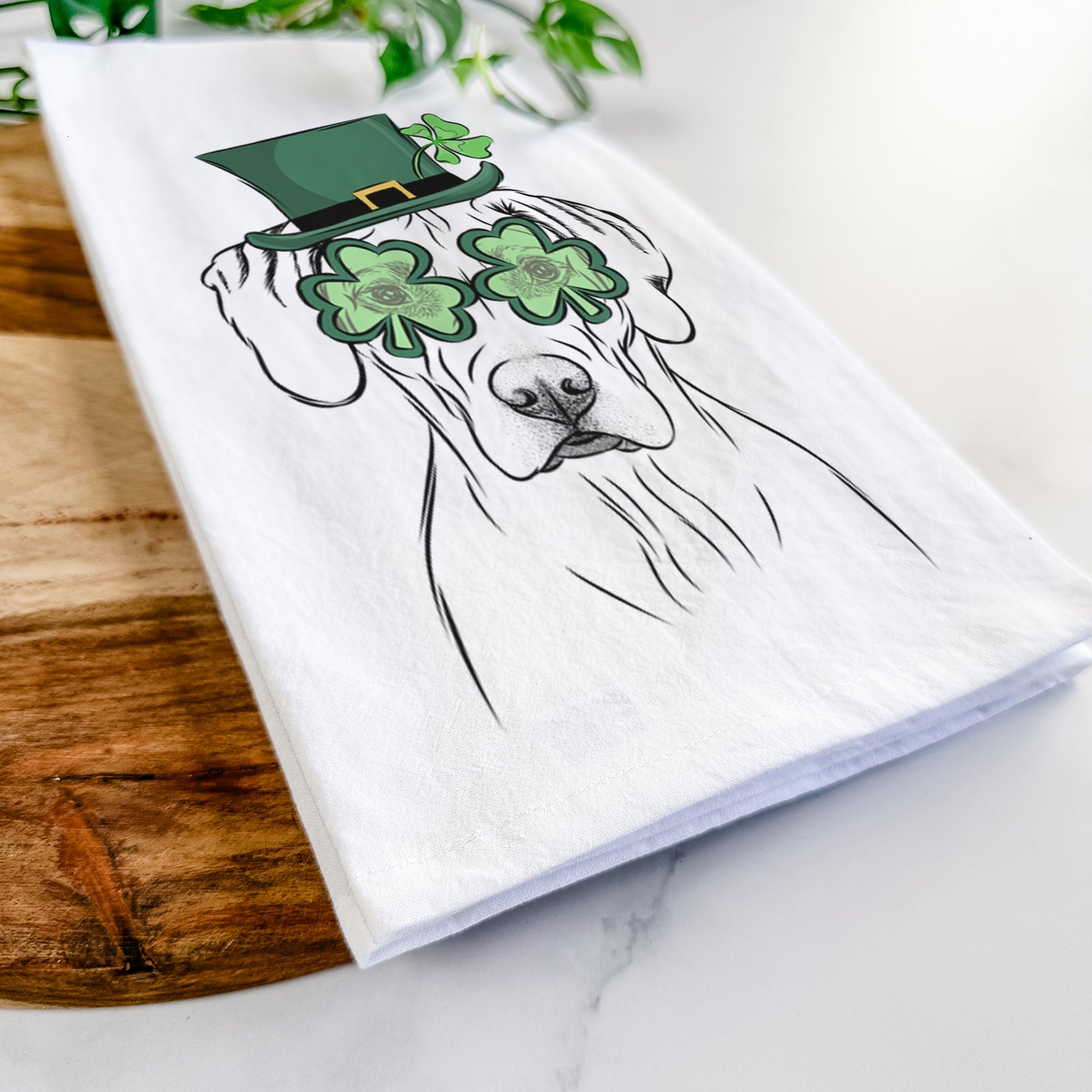 Hand-drawn sketch of Reid the Rhodesian Ridgeback wearing a St. Patrick's Day leprechaun hat and bow tie on a tea towel
