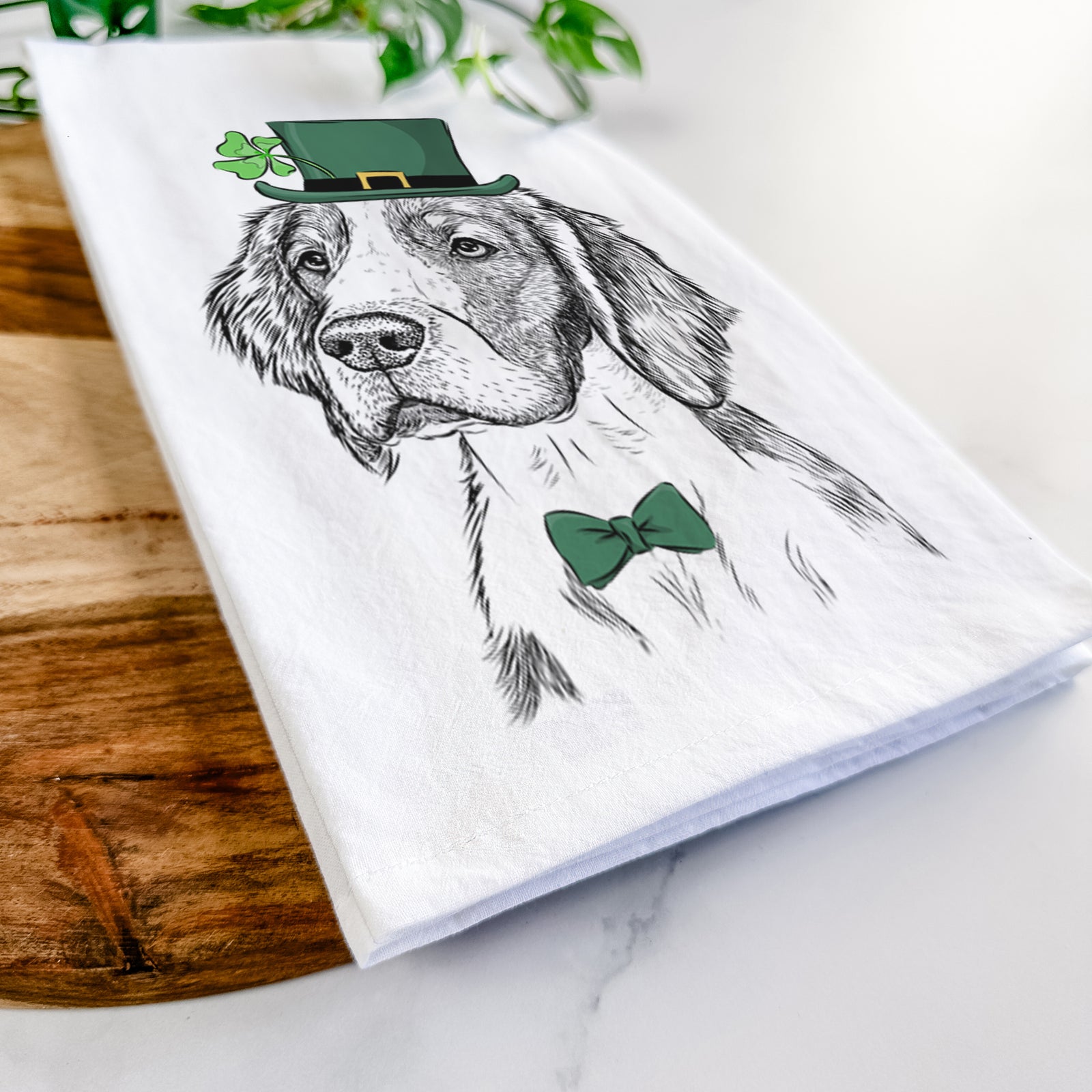 Hand-drawn sketch of Roxy the Welsh Springer Spaniel wearing a St. Patrick's Day leprechaun hat and bow tie on a tea towel