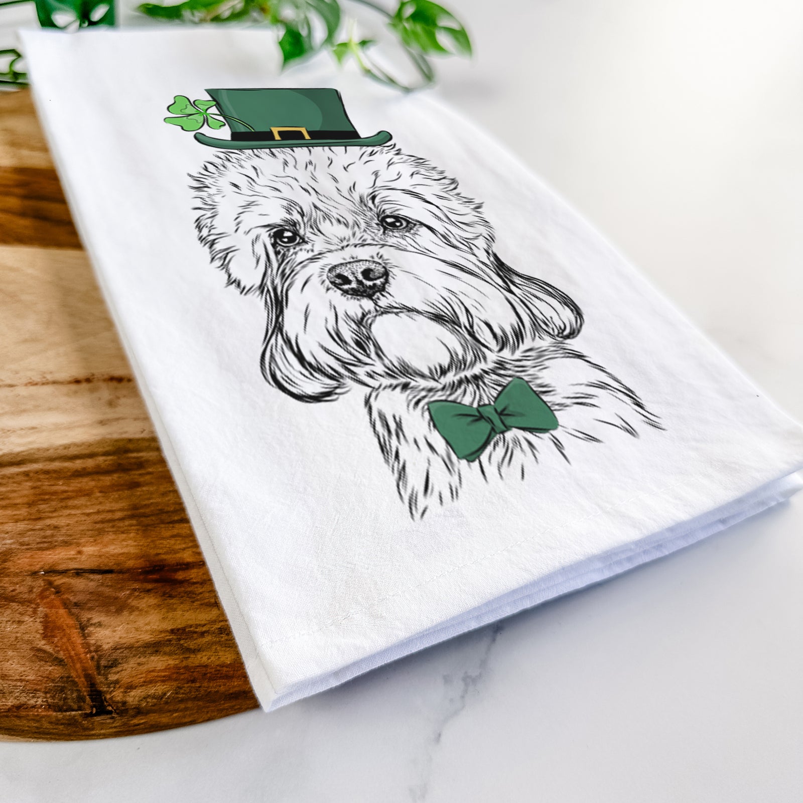 Hand-drawn sketch of Sir Walter the Dandie Dinmont Terrier wearing a St. Patrick's Day leprechaun hat and bow tie on a tea towel
