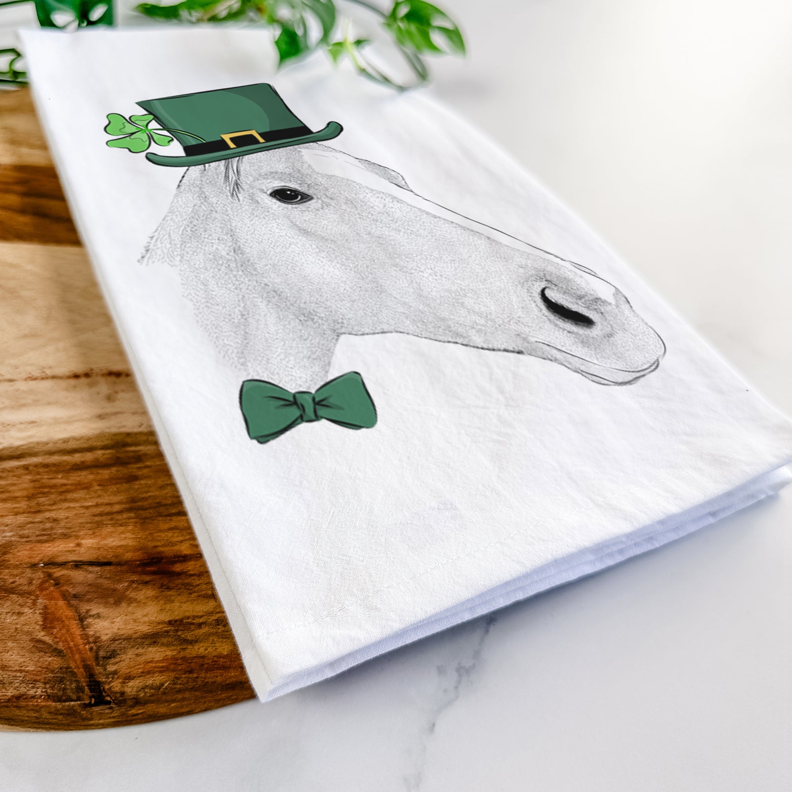 Hand-drawn sketch of Westley the Horse wearing a St. Patrick's Day leprechaun hat and bow tie on a tea towel