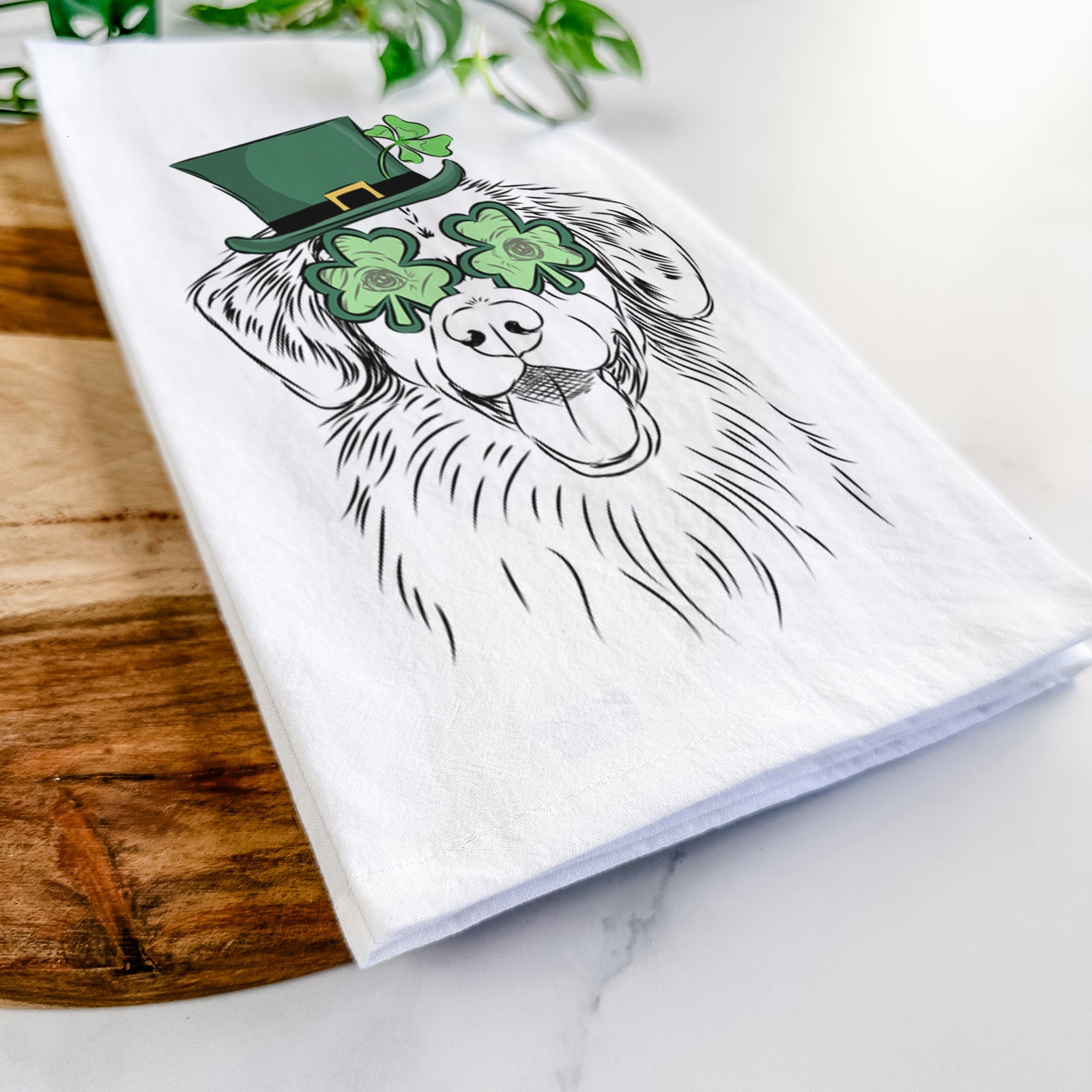 Hand-drawn sketch of Weston the Nova Scotia Duck Tolling Retriever wearing a St. Patrick's Day leprechaun hat and bow tie on a tea towel