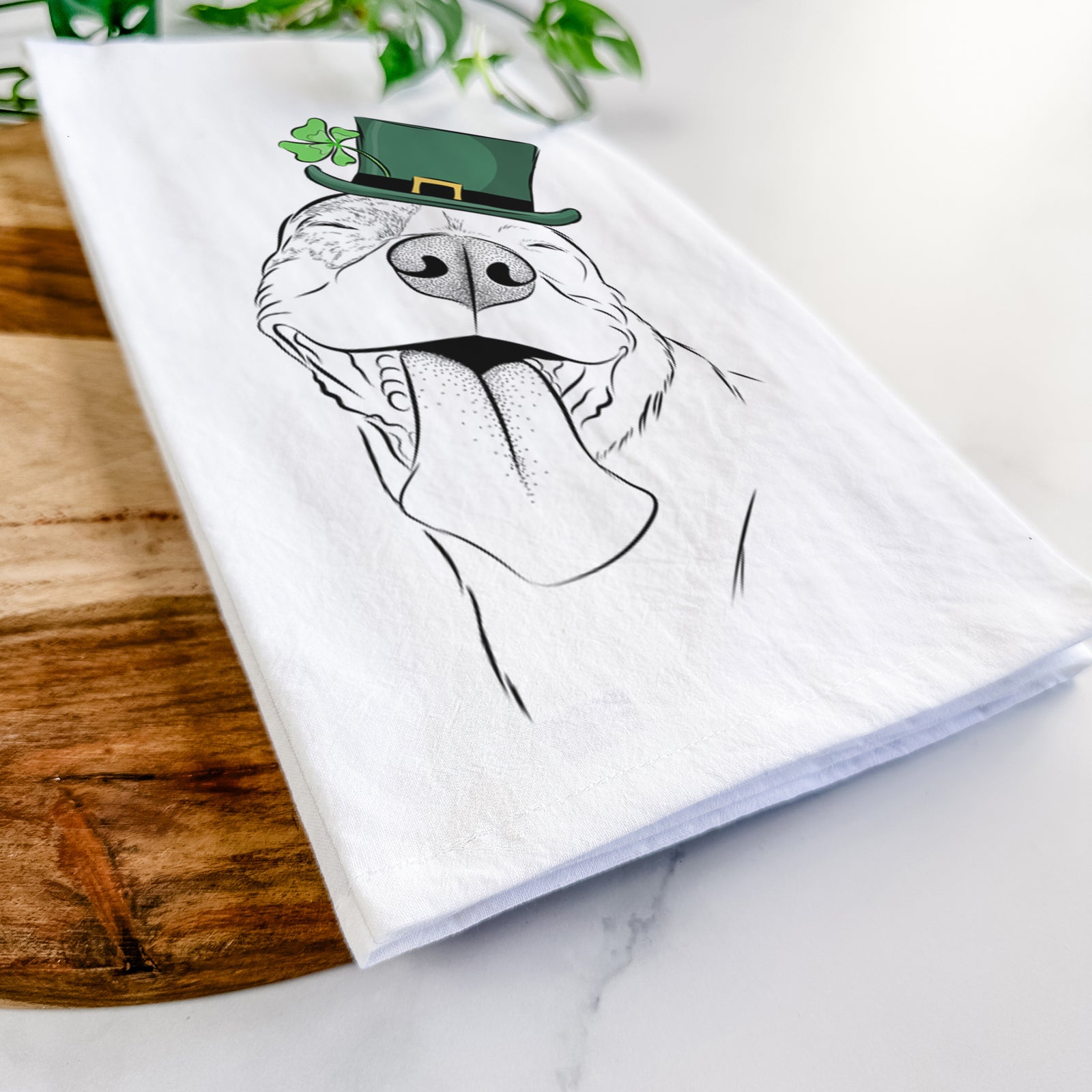 Hand-drawn sketch of Xena the American Staffordshire Terrier wearing a St. Patrick's Day leprechaun hat and bow tie on a tea towel