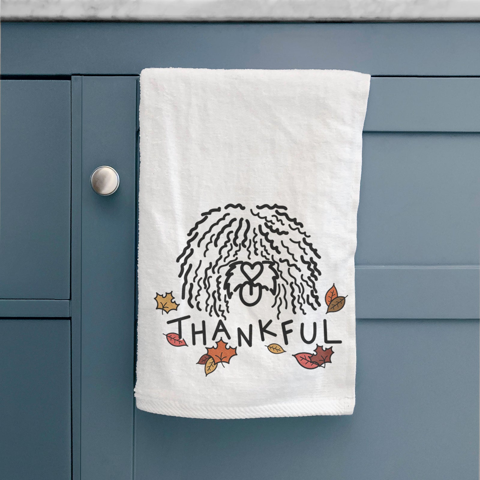 Minimalist line drawing of Alba the Spanish Water Dog with 'Thankful' lettering on a decorative hand towel