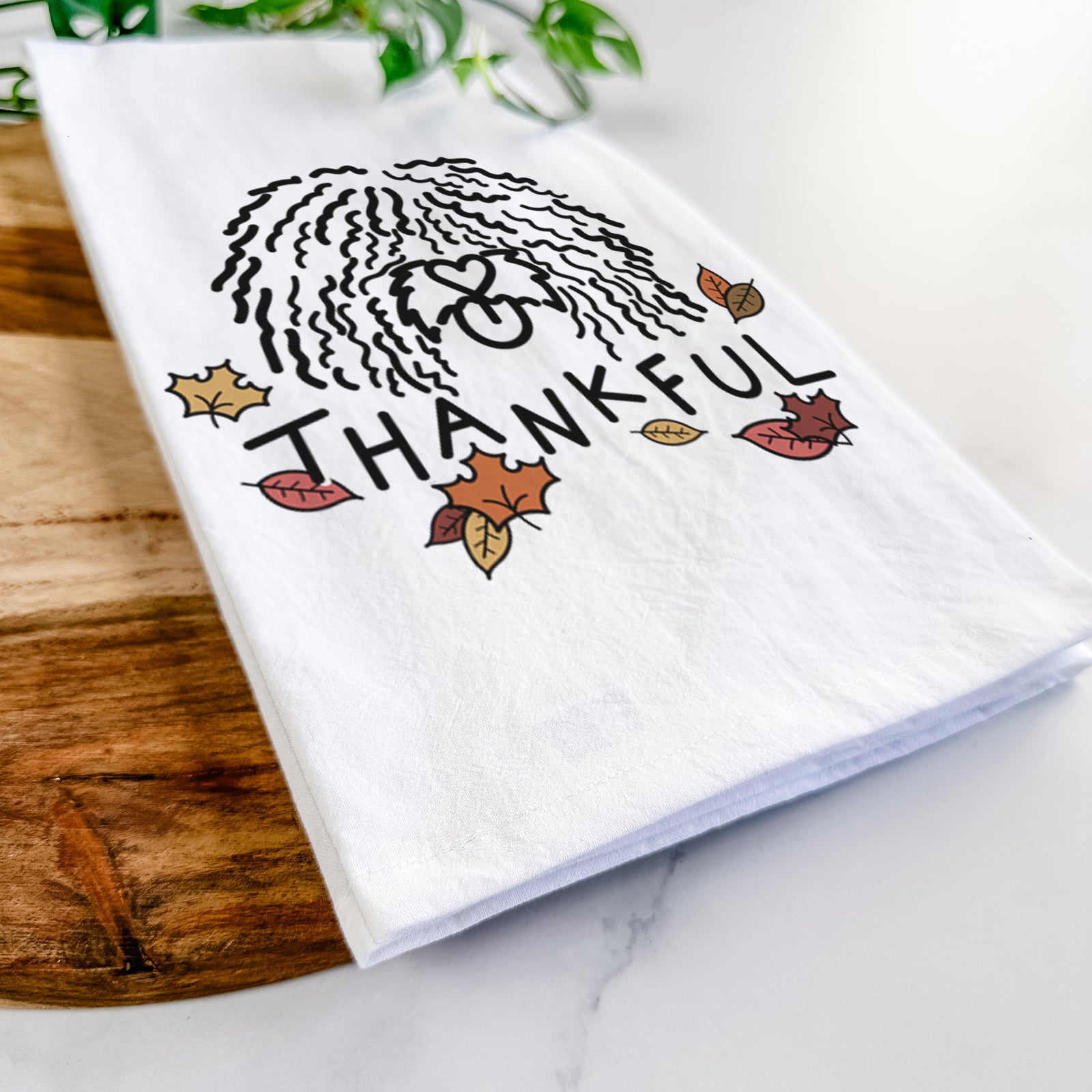 Minimalist line drawing of Alba the Spanish Water Dog with 'Thankful' lettering on a tea towel