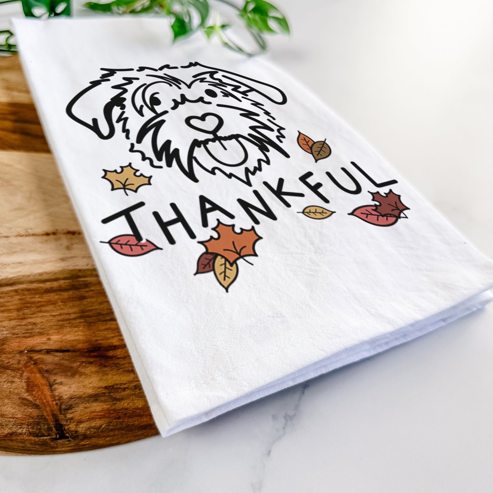Minimalist line drawing of Amal the Scottish Terrier Border Collie Mix with 'Thankful' lettering on a tea towel