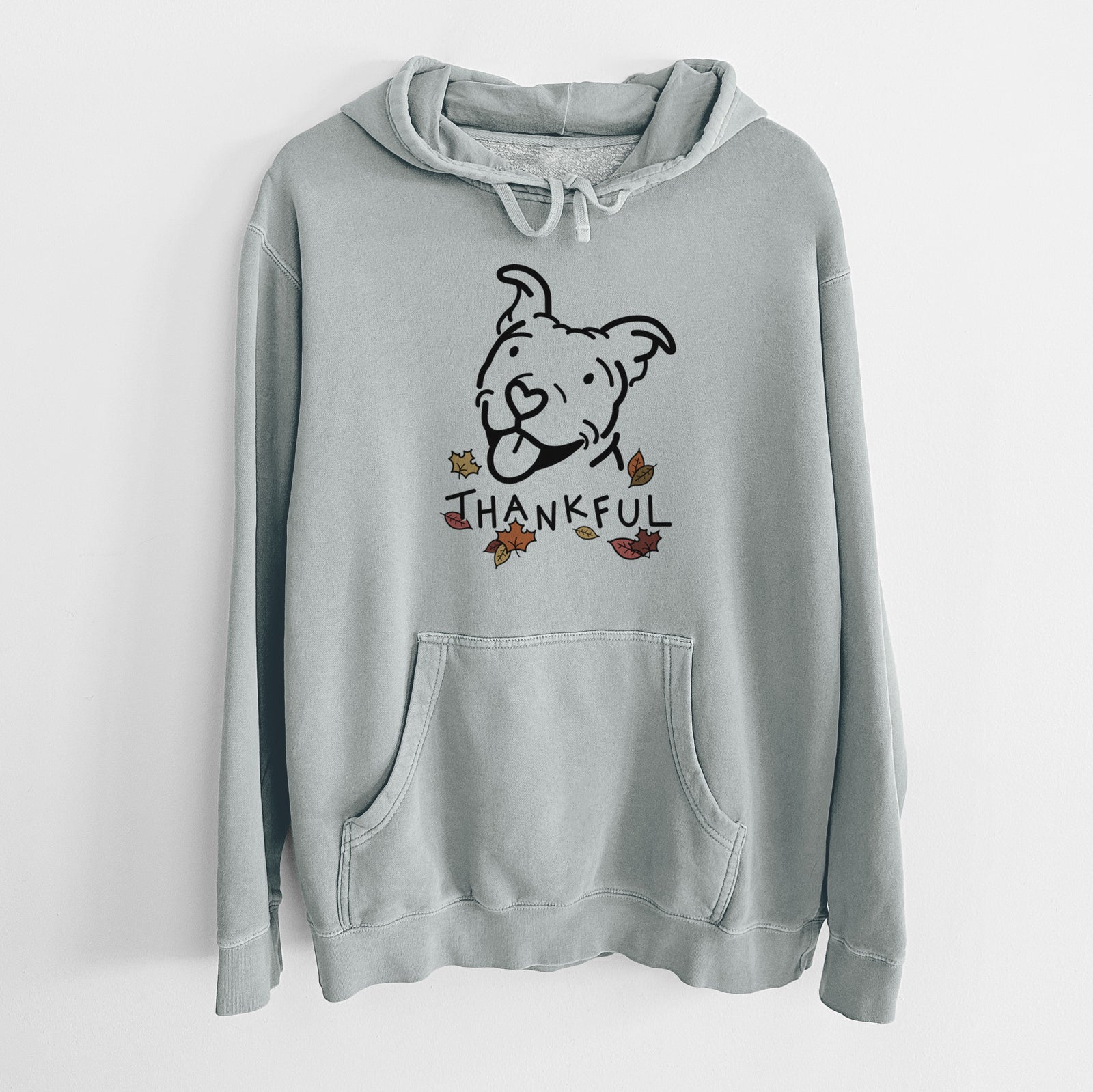 Minimalist line drawing of Arlo the Pitbull with 'Thankful' lettering on a Sage Unisex pigment dyed hoodie