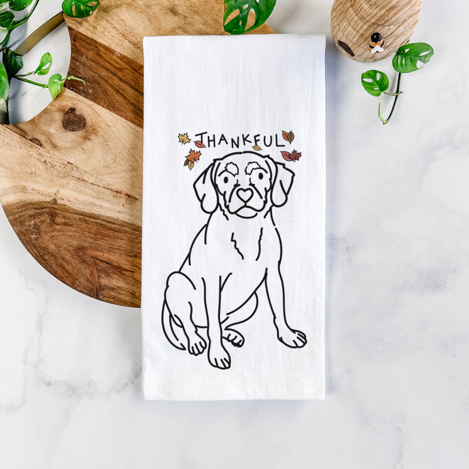 Minimalist line drawing of Babs the Puggle with 'Thankful' lettering on a tea towel