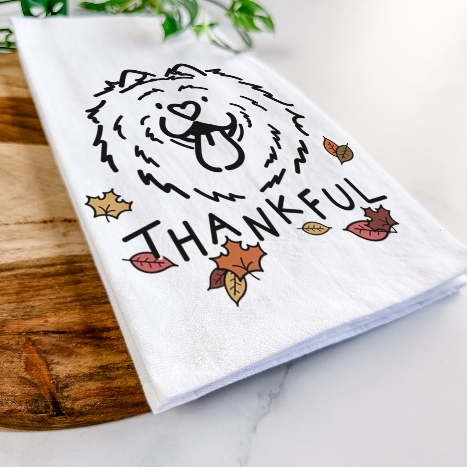 Minimalist line drawing of Bear the Chow Chow with 'Thankful' lettering on a tea towel