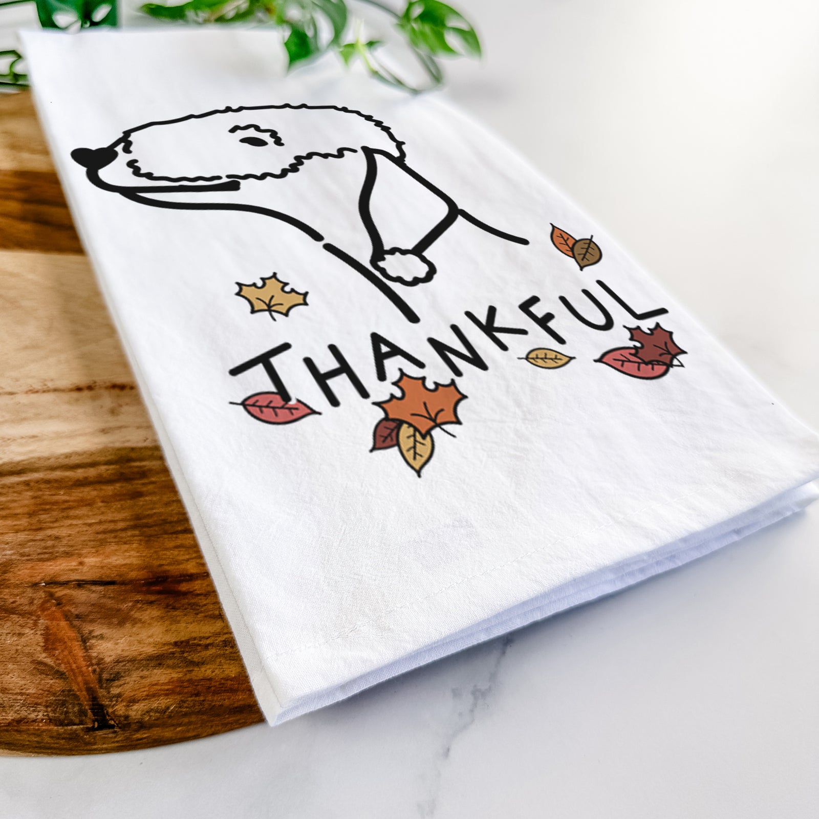 Minimalist line drawing of a Bedlington Terrier with 'Thankful' lettering on a tea towel