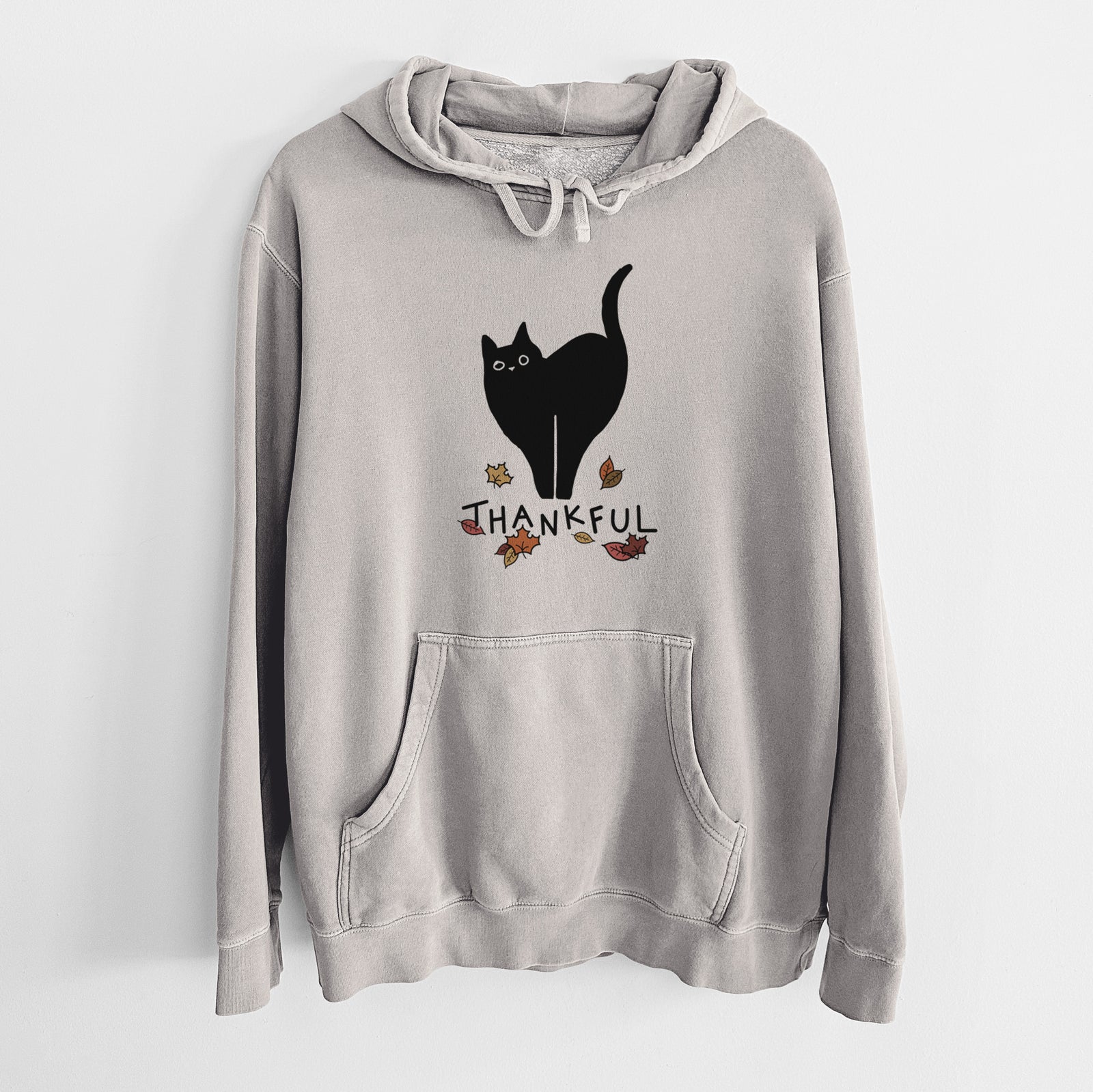 Minimalist line drawing of Bella the Black Cat with 'Thankful' lettering on a Cement Unisex pigment dyed hoodie