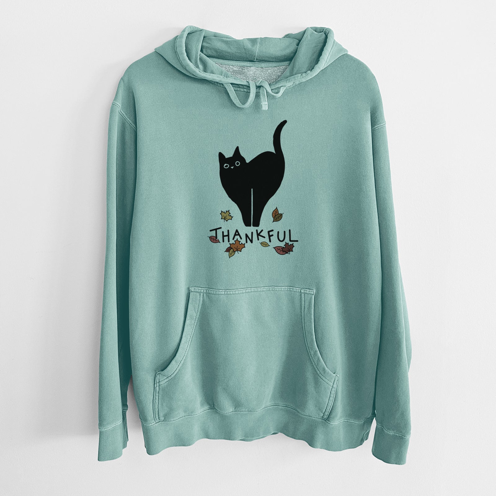 Minimalist line drawing of Bella the Black Cat with 'Thankful' lettering on a Mint Unisex pigment dyed hoodie