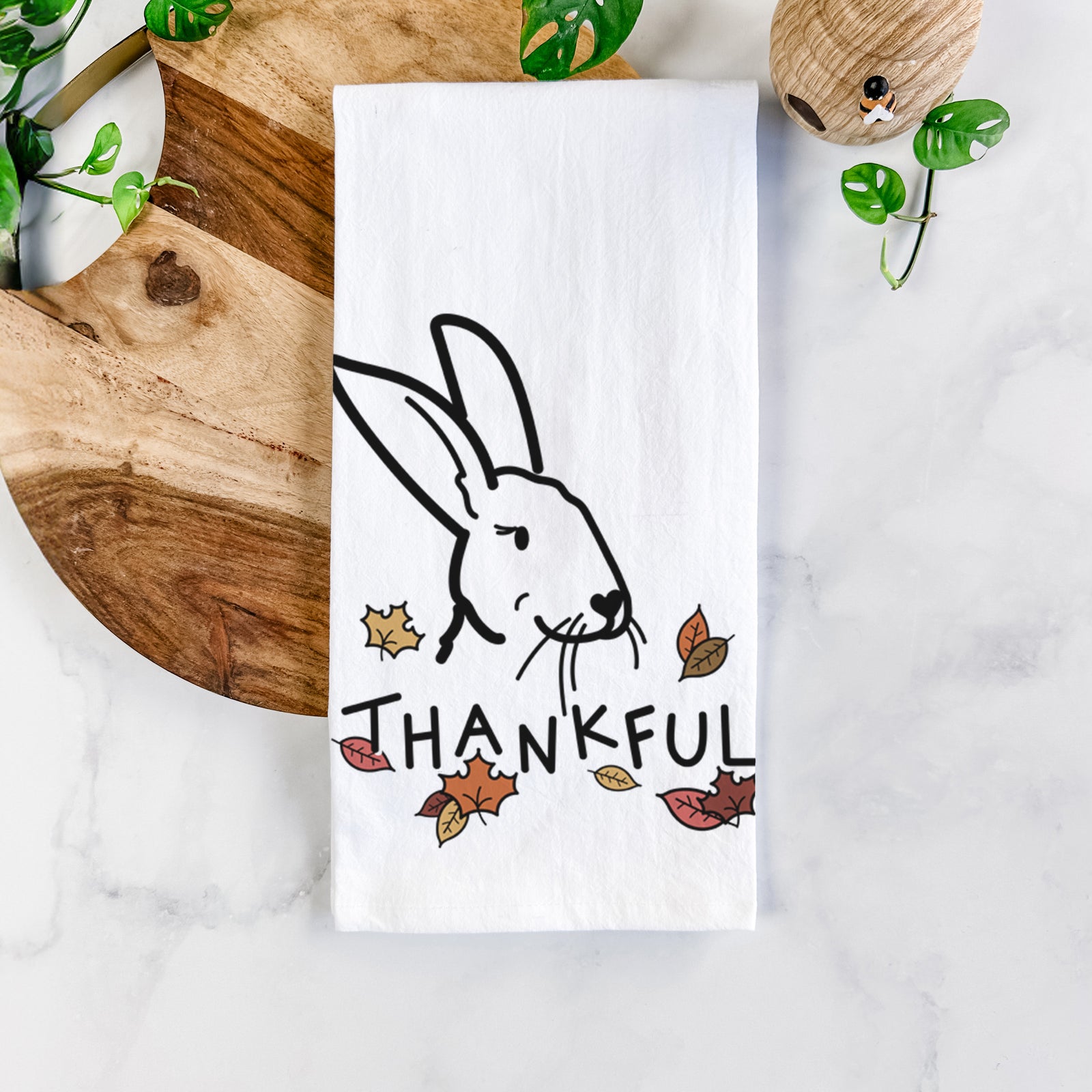 Minimalist line drawing of Betsy the Rex Rabbit with 'Thankful' lettering on a tea towel