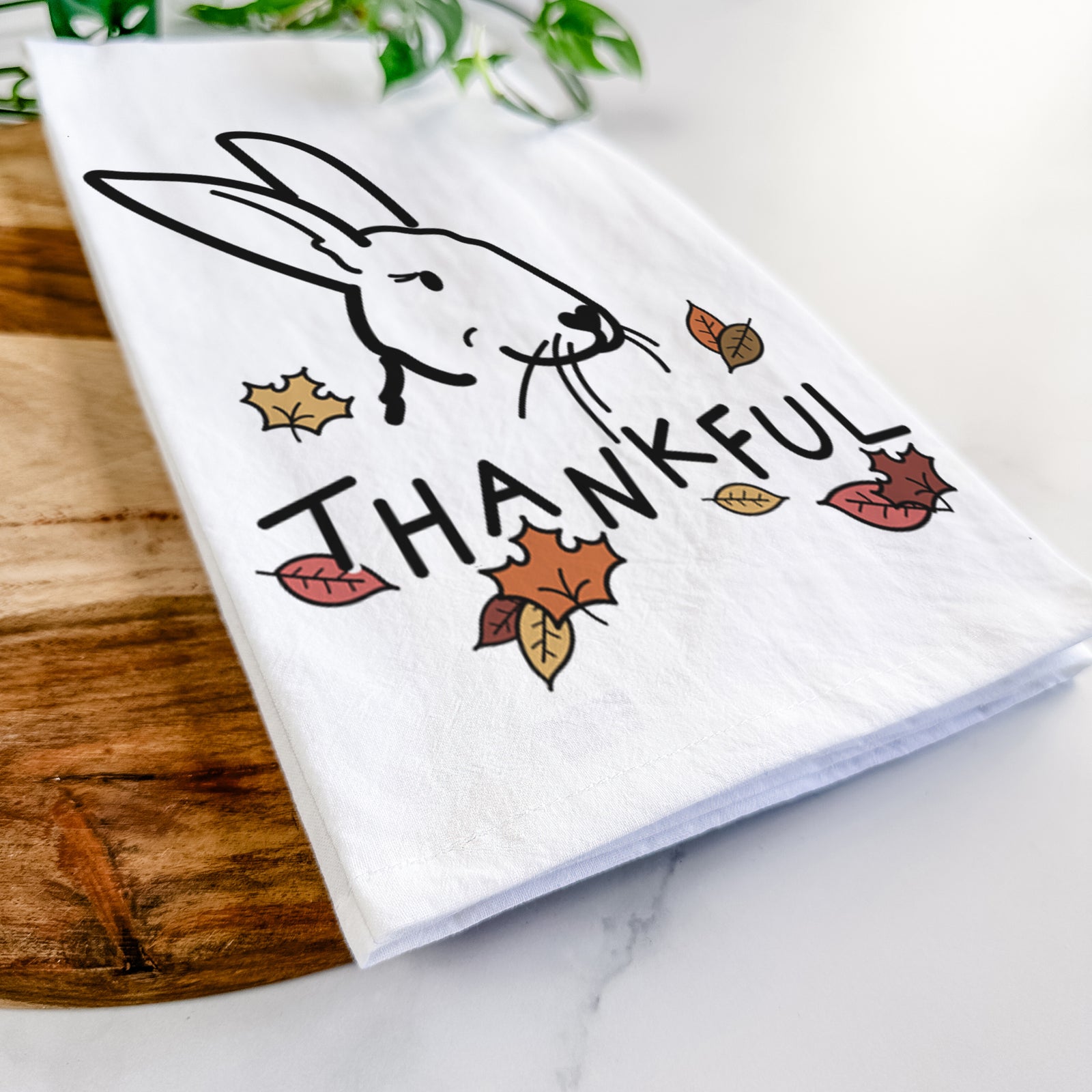Minimalist line drawing of Betsy the Rex Rabbit with 'Thankful' lettering on a tea towel