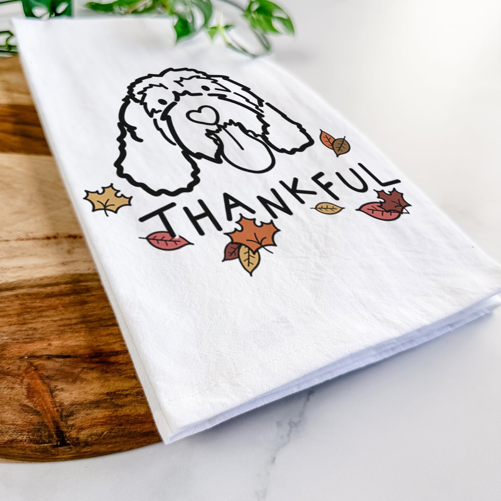 Minimalist line drawing of Bo the Portguese Water Dog with 'Thankful' lettering on a tea towel