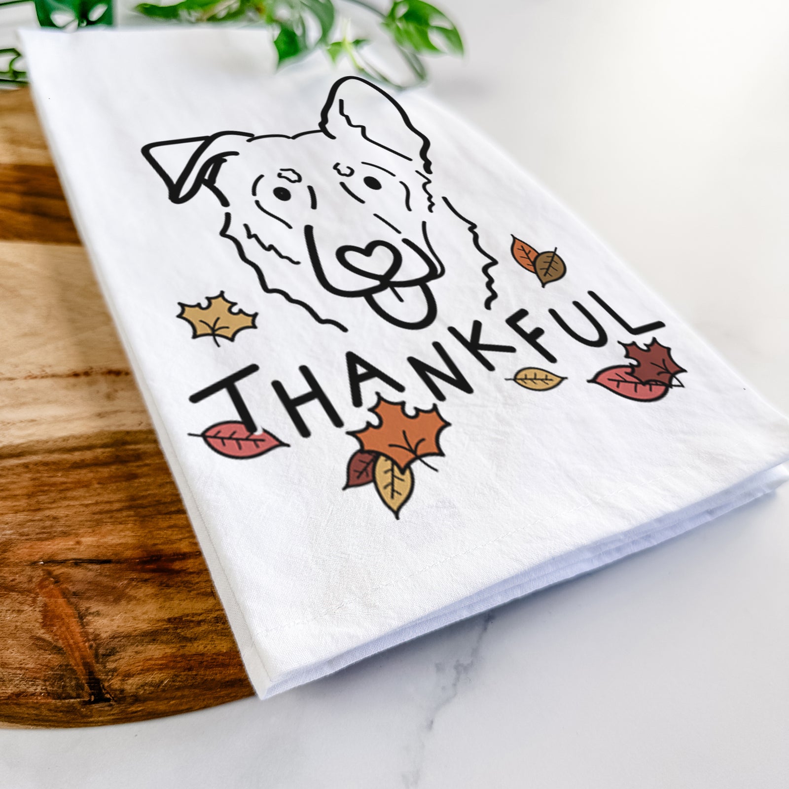 Minimalist line drawing of Bodhi the Shepherd Mix with 'Thankful' lettering on a tea towel