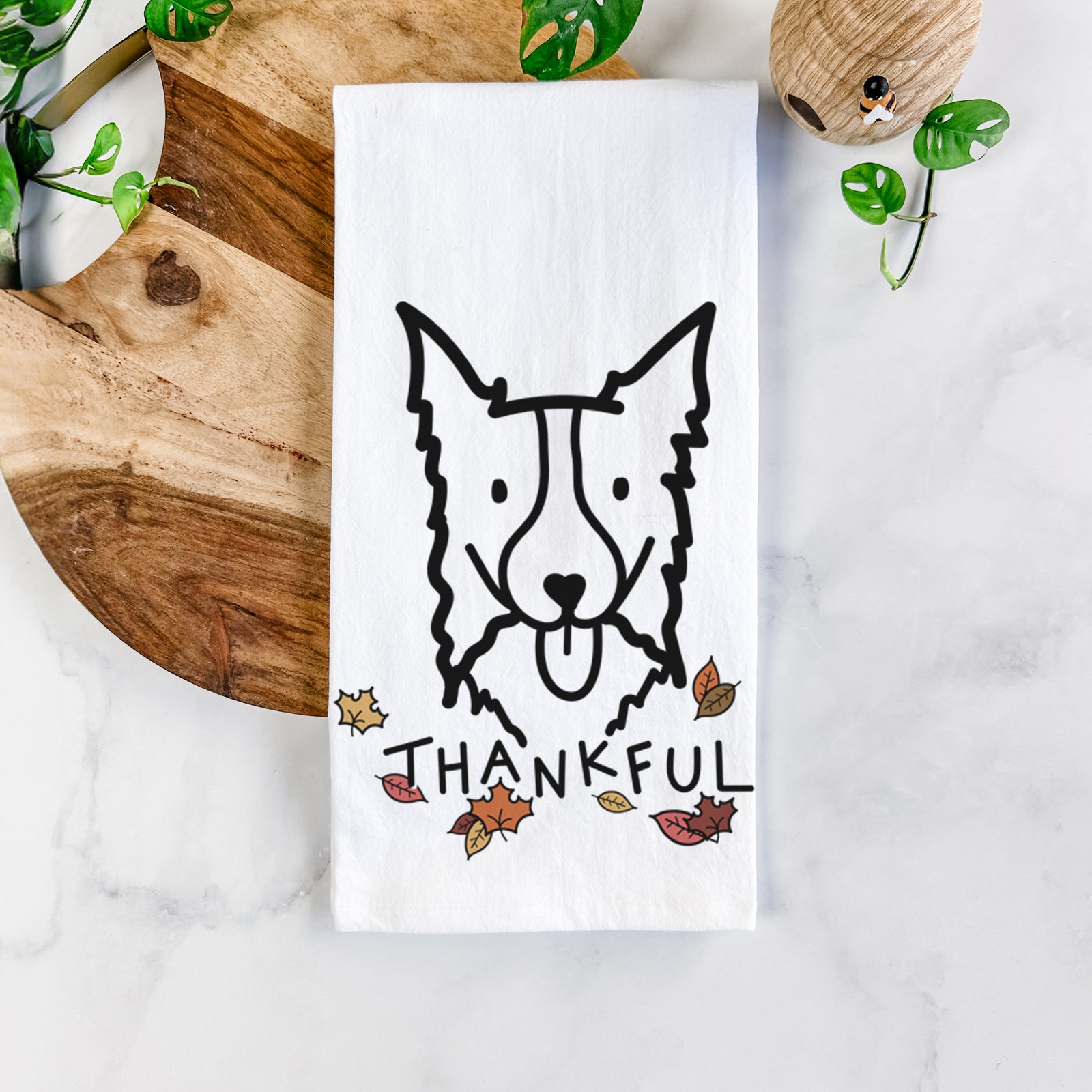 Minimalist line drawing of a Border Collie with 'Thankful' lettering on a tea towel