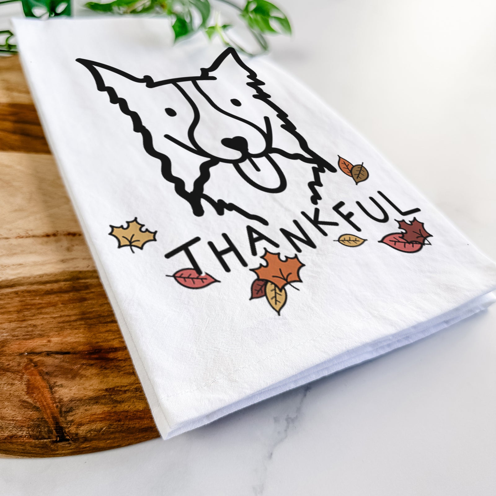 Minimalist line drawing of a Border Collie with 'Thankful' lettering on a tea towel