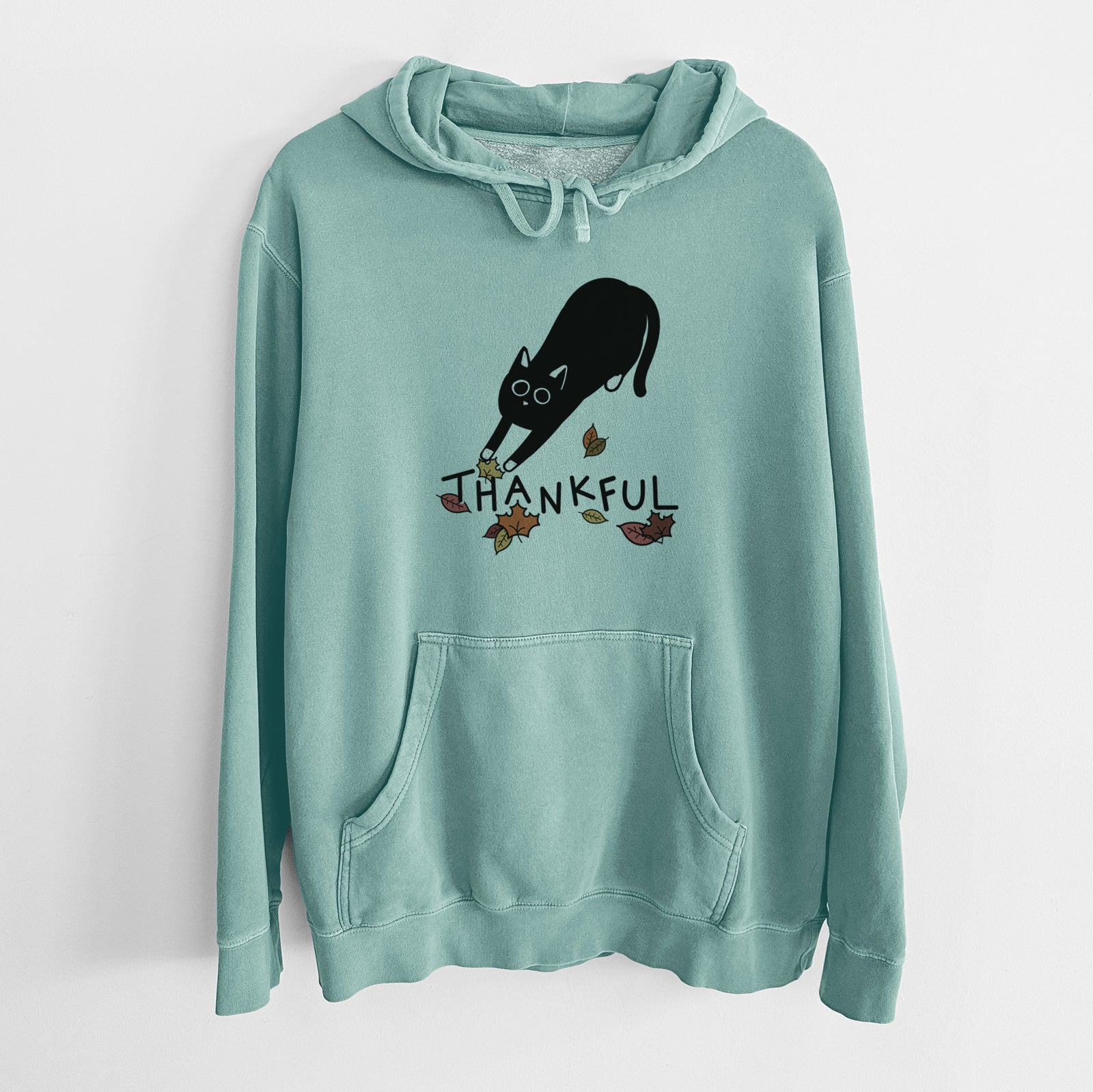 Minimalist line drawing of Bug the Black Cat with 'Thankful' lettering on a Mint Unisex pigment dyed hoodie