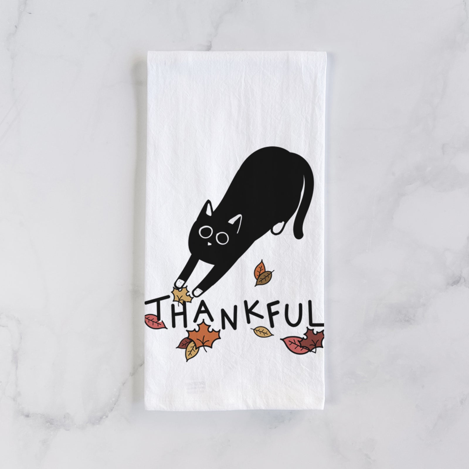 Minimalist line drawing of Bug the Black Cat with 'Thankful' lettering on a tea towel