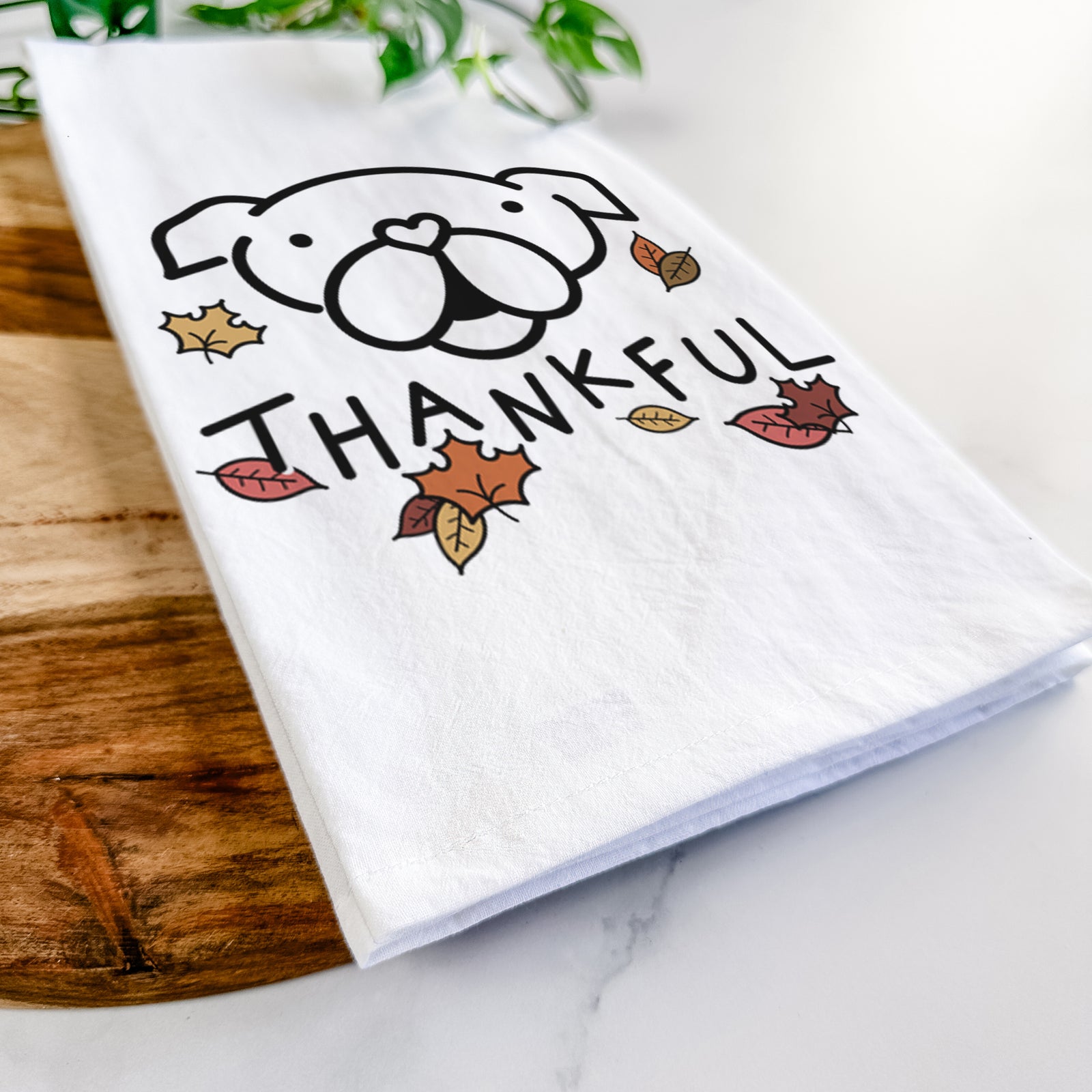 Minimalist line drawing of an English Bulldog with 'Thankful' lettering on a tea towel