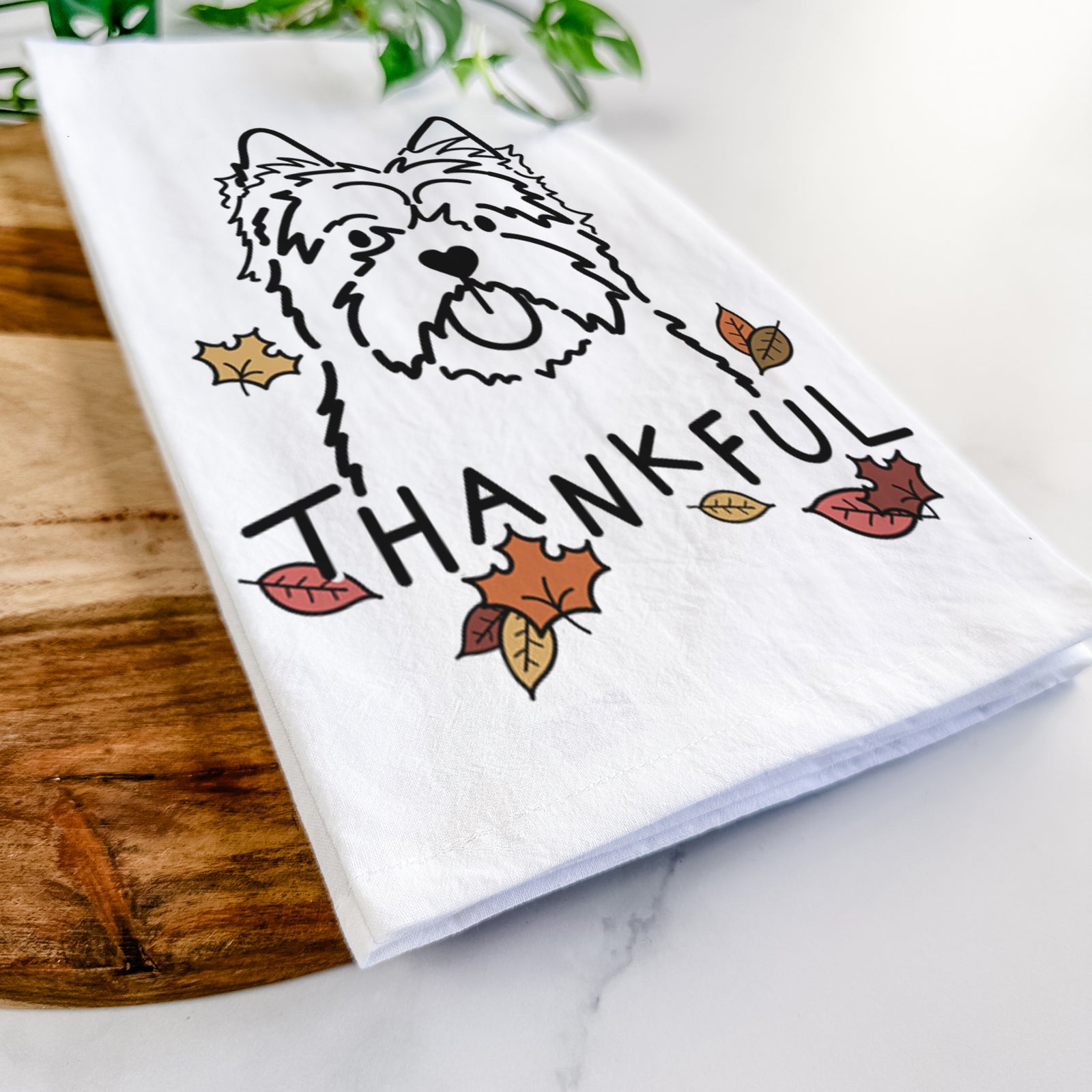 Minimalist line drawing of a Cairn Terrier with 'Thankful' lettering on a tea towel