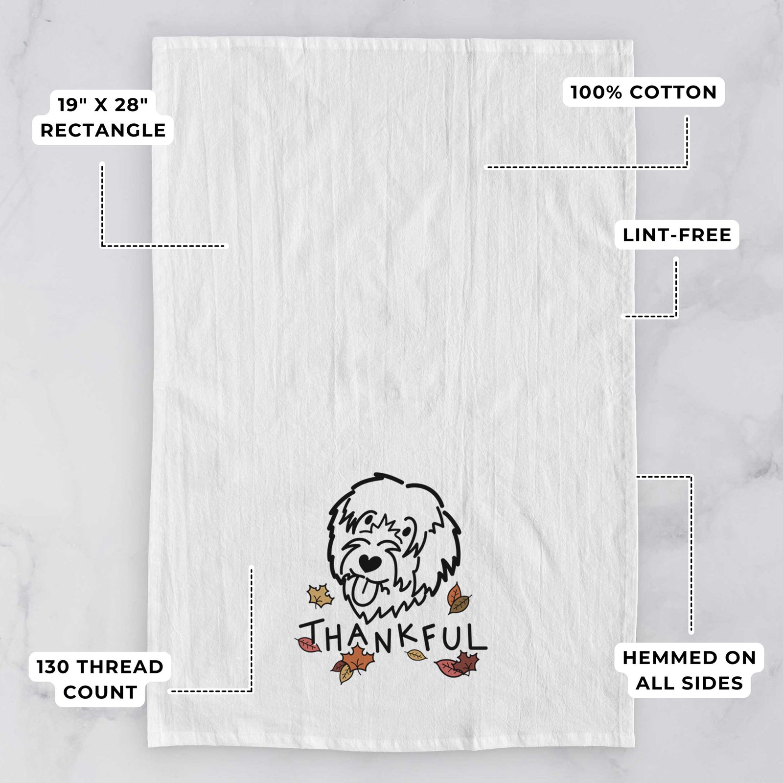 Minimalist line drawing of a Catalan Sheepdog with 'Thankful' lettering on a tea towel, with feature callouts: 19 x 28 inch rectangle, 100% cotton, lint-free, 120 thread count, hemmed on all sides
