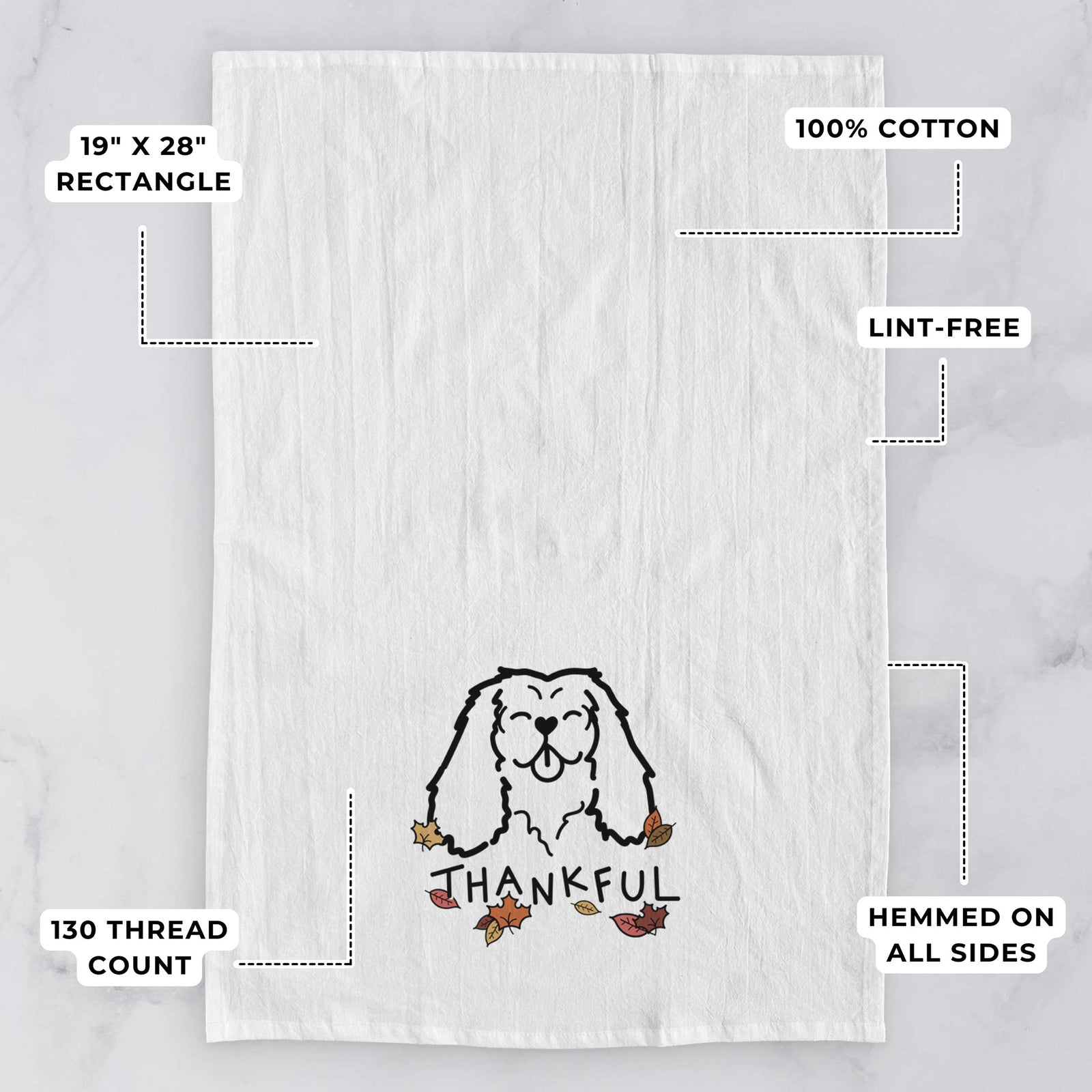 Minimalist line drawing of a Cavalier King Charles Spaniel with 'Thankful' lettering on a tea towel, with feature callouts: 19 x 28 inch rectangle, 100% cotton, lint-free, 120 thread count, hemmed on all sides
