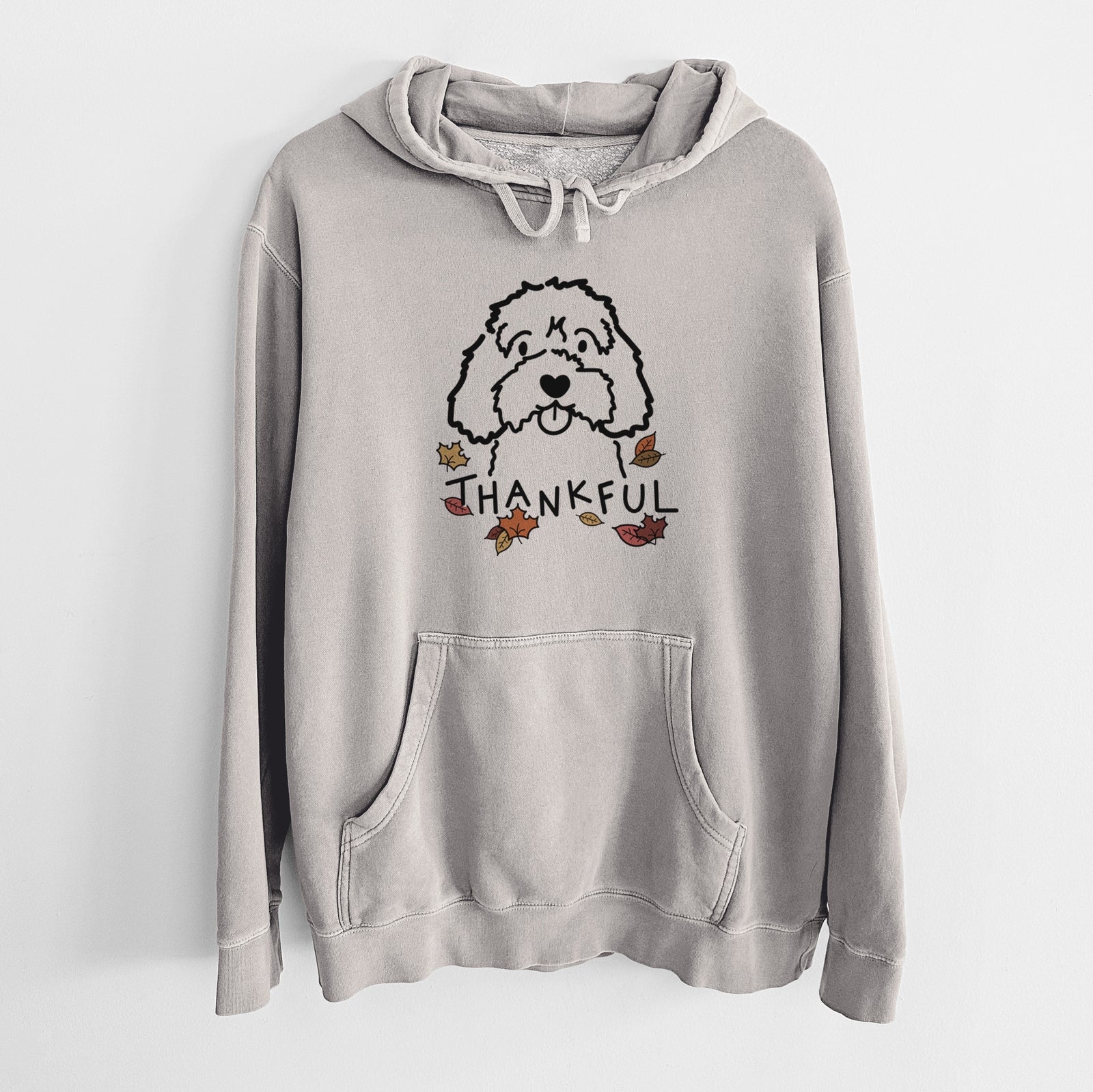 Minimalist line drawing of a Cavapoo with 'Thankful' lettering on a Cement Unisex pigment dyed hoodie