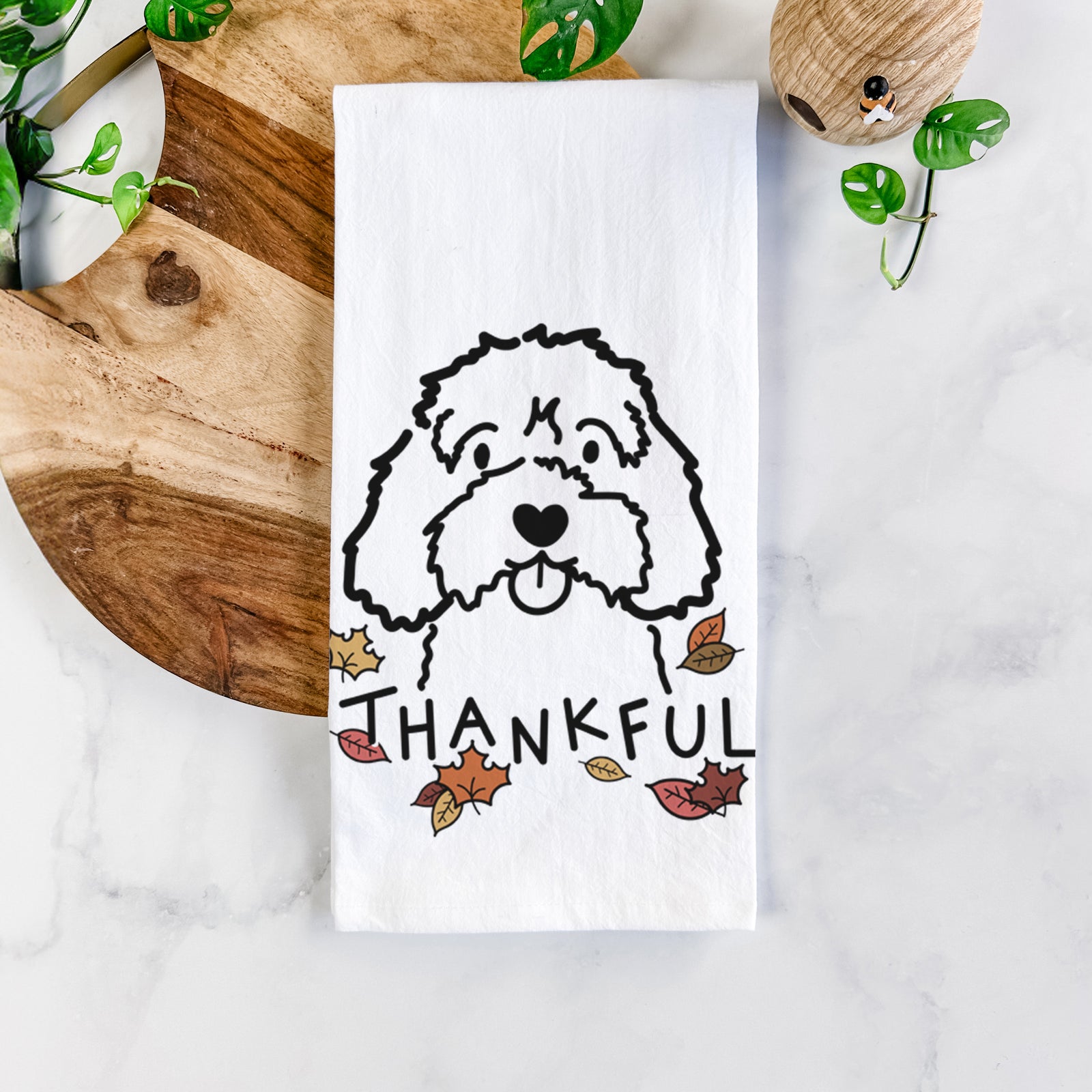 Minimalist line drawing of a Cavapoo with 'Thankful' lettering on a tea towel