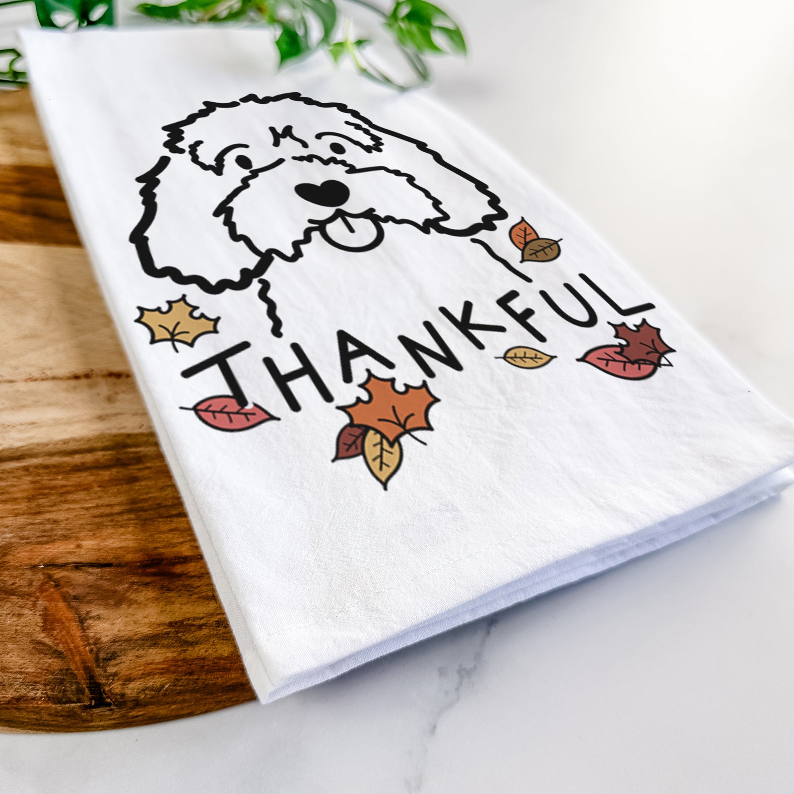 Minimalist line drawing of a Cavapoo with 'Thankful' lettering on a tea towel