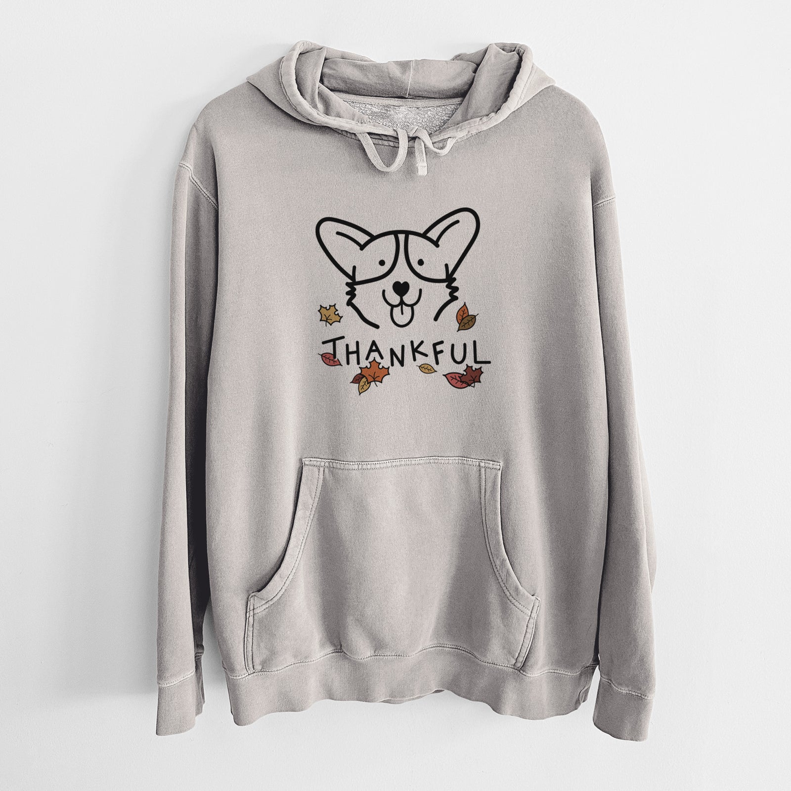 Minimalist line drawing of a Corgi with 'Thankful' lettering on a Cement Unisex pigment dyed hoodie