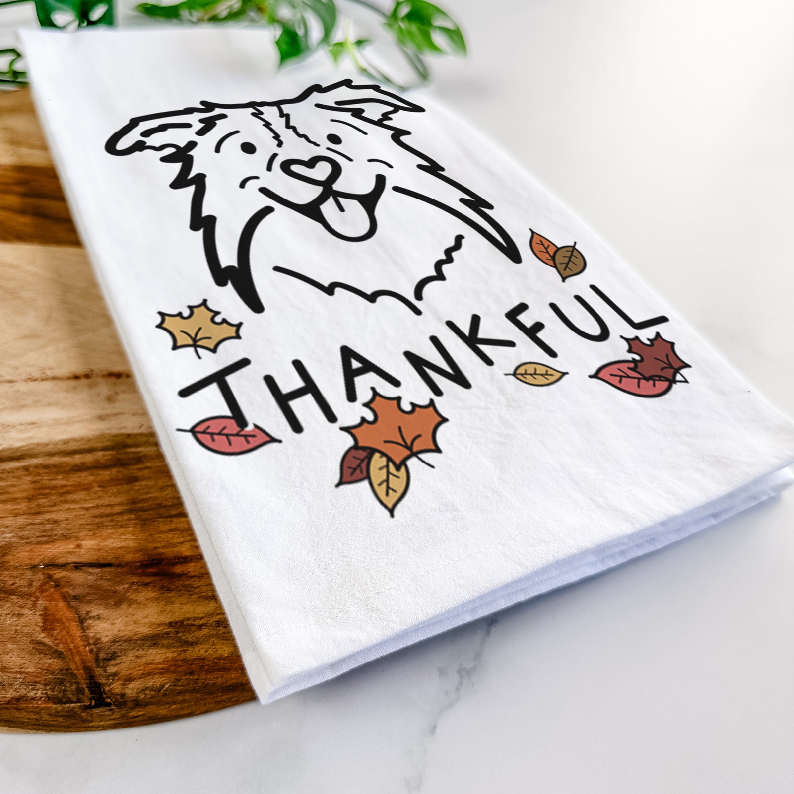 Minimalist line drawing of Cricket the Border Collie with 'Thankful' lettering on a tea towel