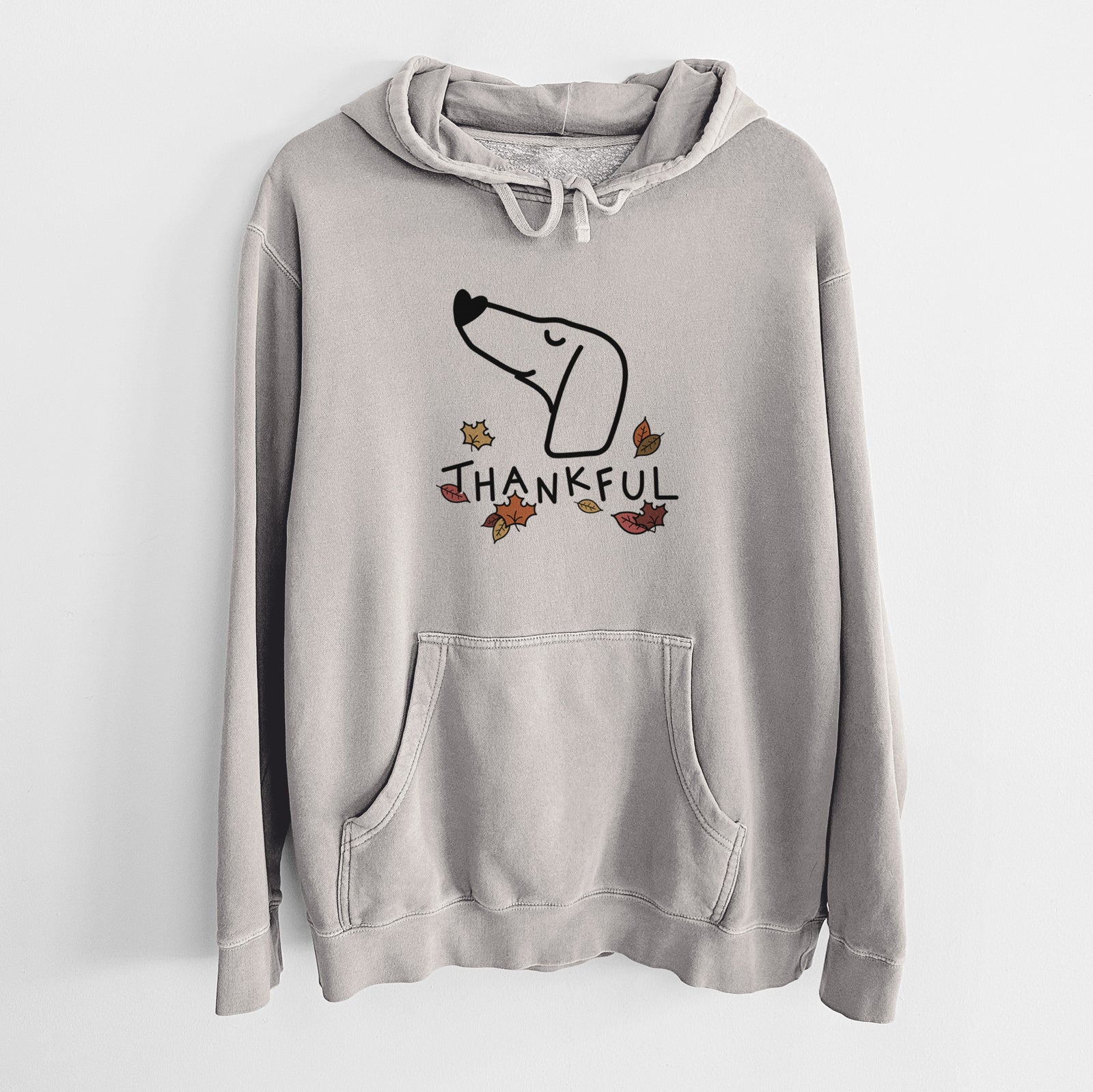 Minimalist line drawing of a Dachshund with 'Thankful' lettering on a Cement Unisex pigment dyed hoodie