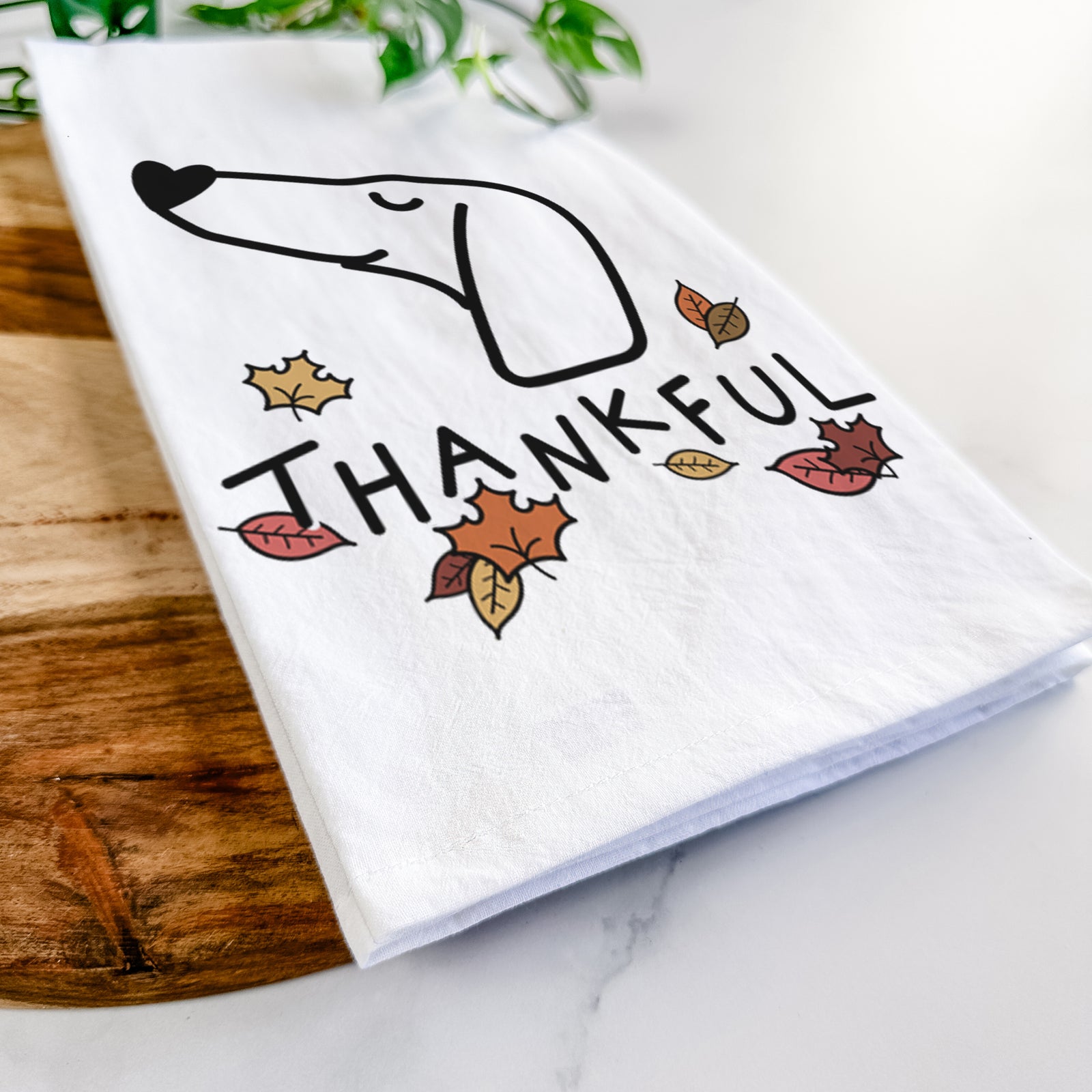 Minimalist line drawing of a Dachshund with 'Thankful' lettering on a tea towel