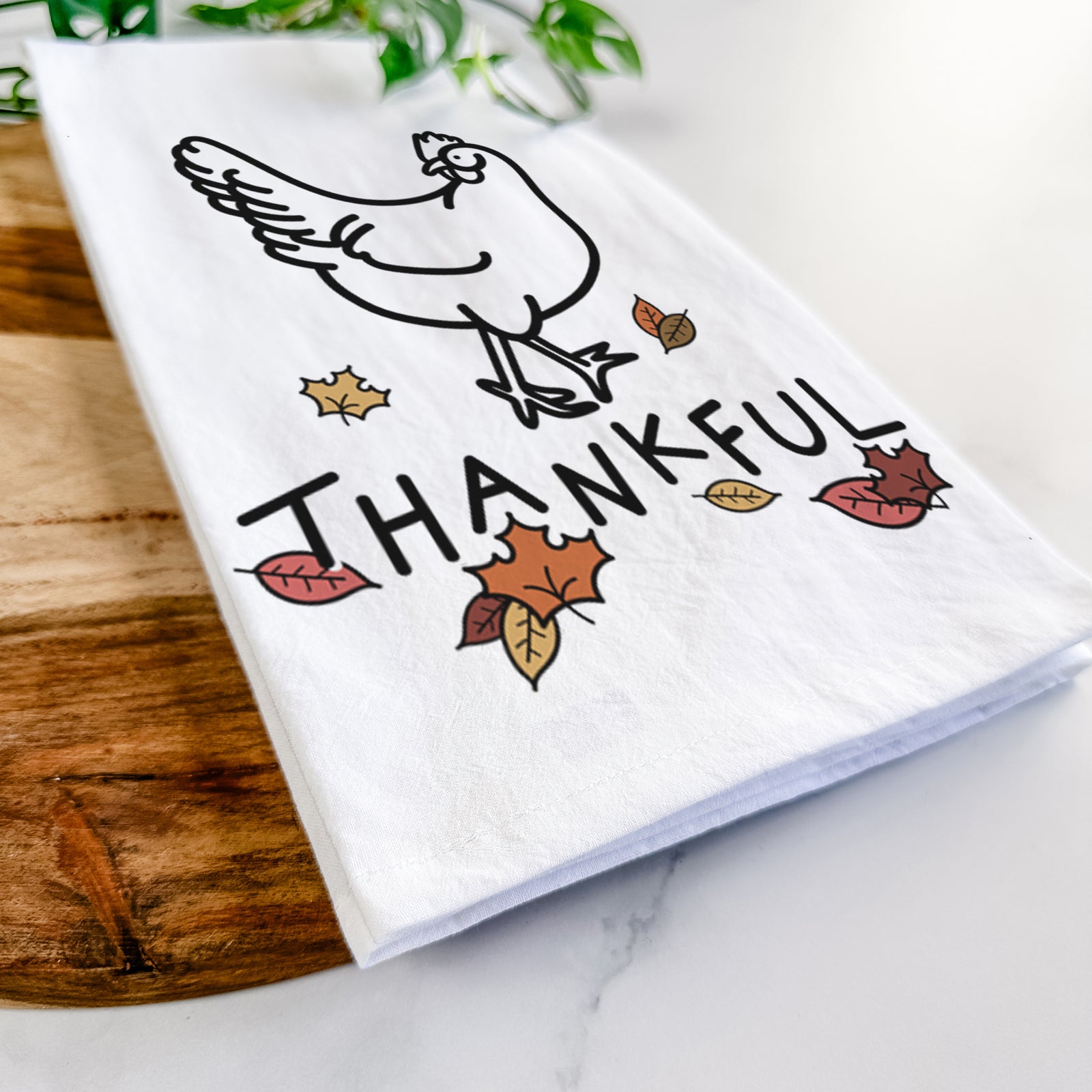 Minimalist line drawing of Daisy the Chicken with 'Thankful' lettering on a tea towel