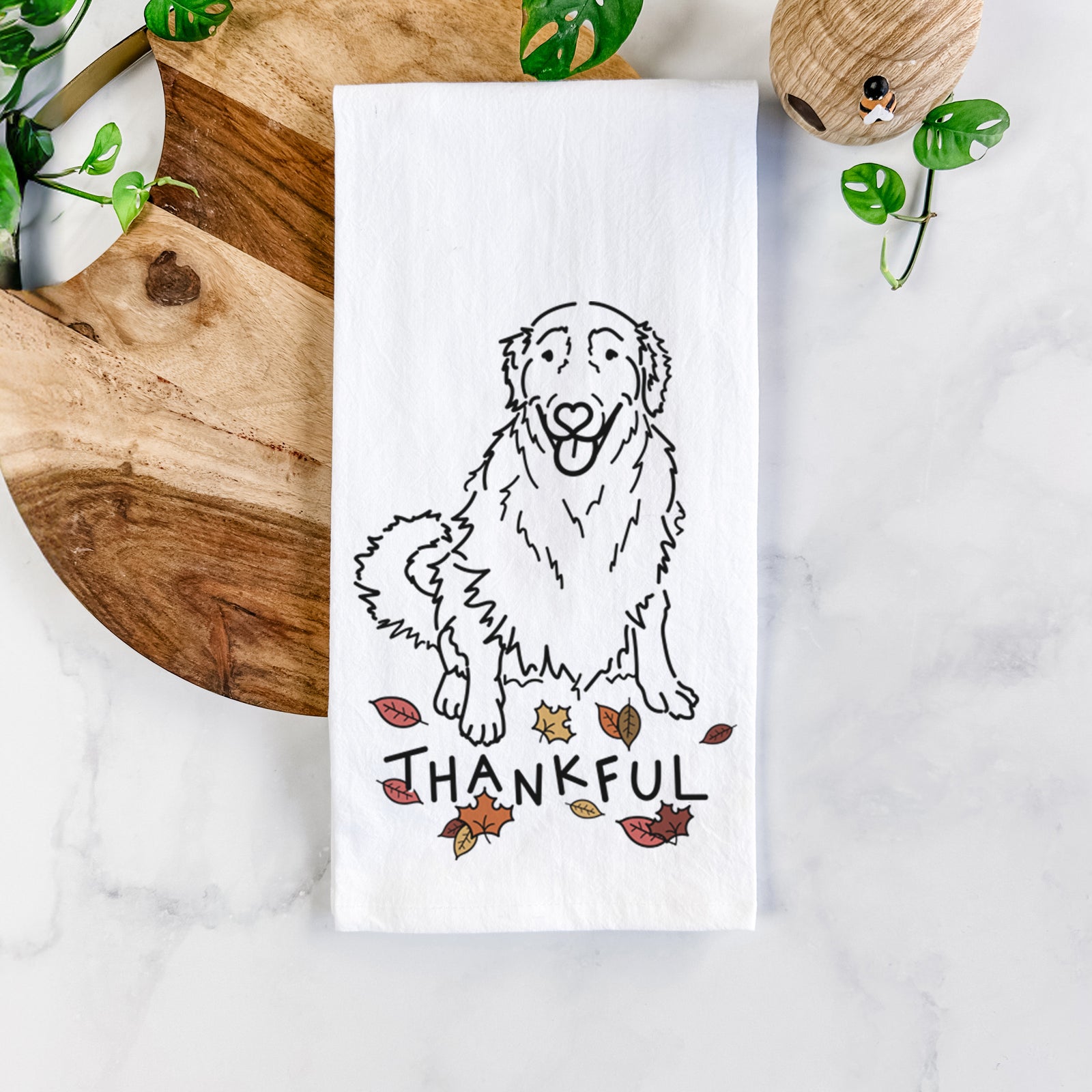 Minimalist line drawing of Daisy the Golden Retriever with 'Thankful' lettering on a tea towel