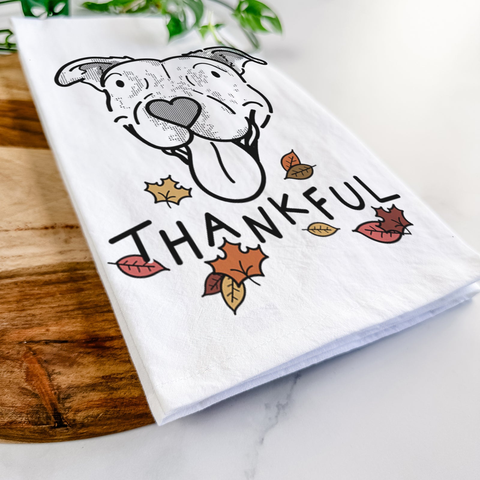 Minimalist line drawing of Dottie the Pitbull Mix with 'Thankful' lettering on a tea towel