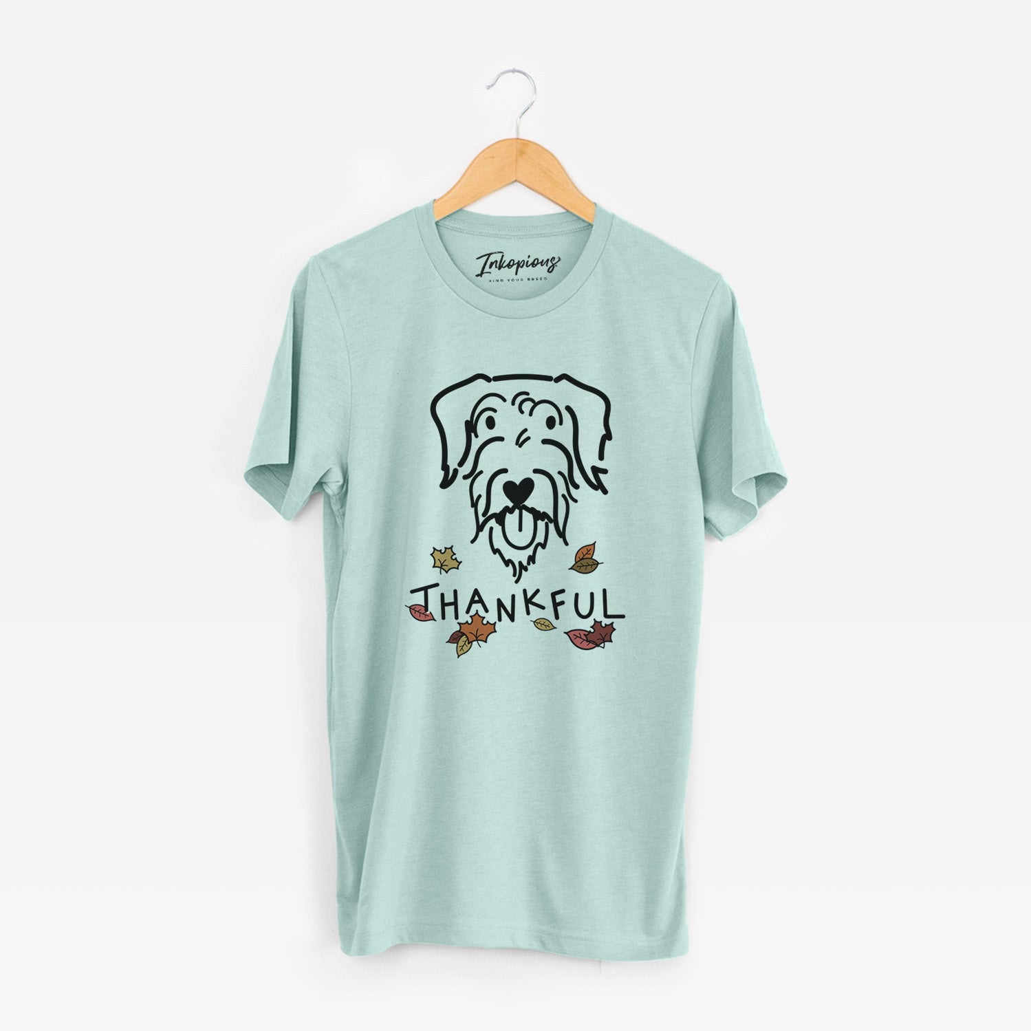 Minimalist line drawing of Dug the Doodle with 'Thankful' lettering on a Heather Sage Unisex crewneck