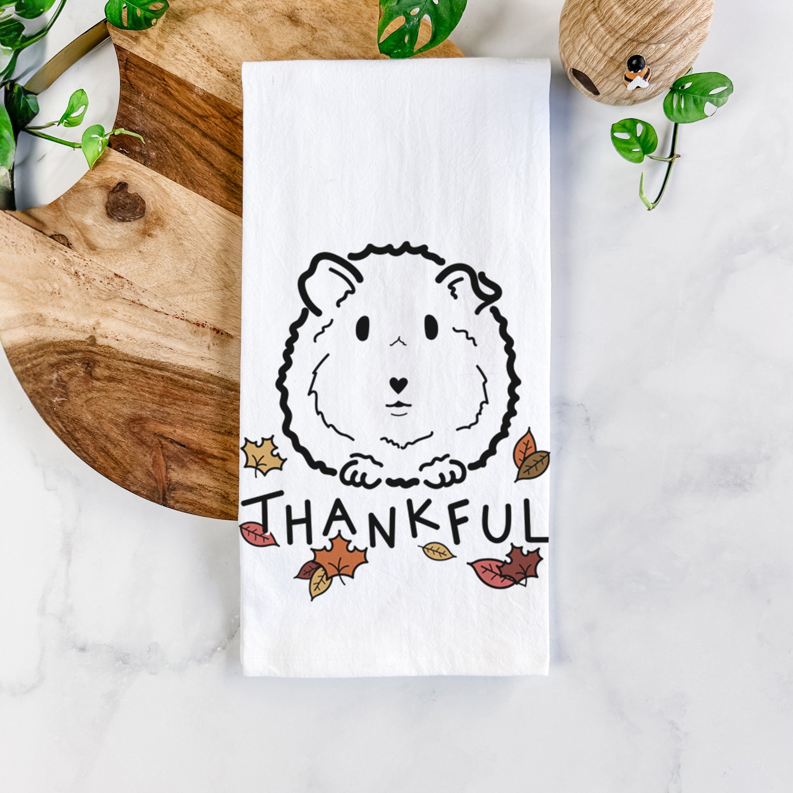 Minimalist line drawing of Duke the Guinea Pig with 'Thankful' lettering on a tea towel