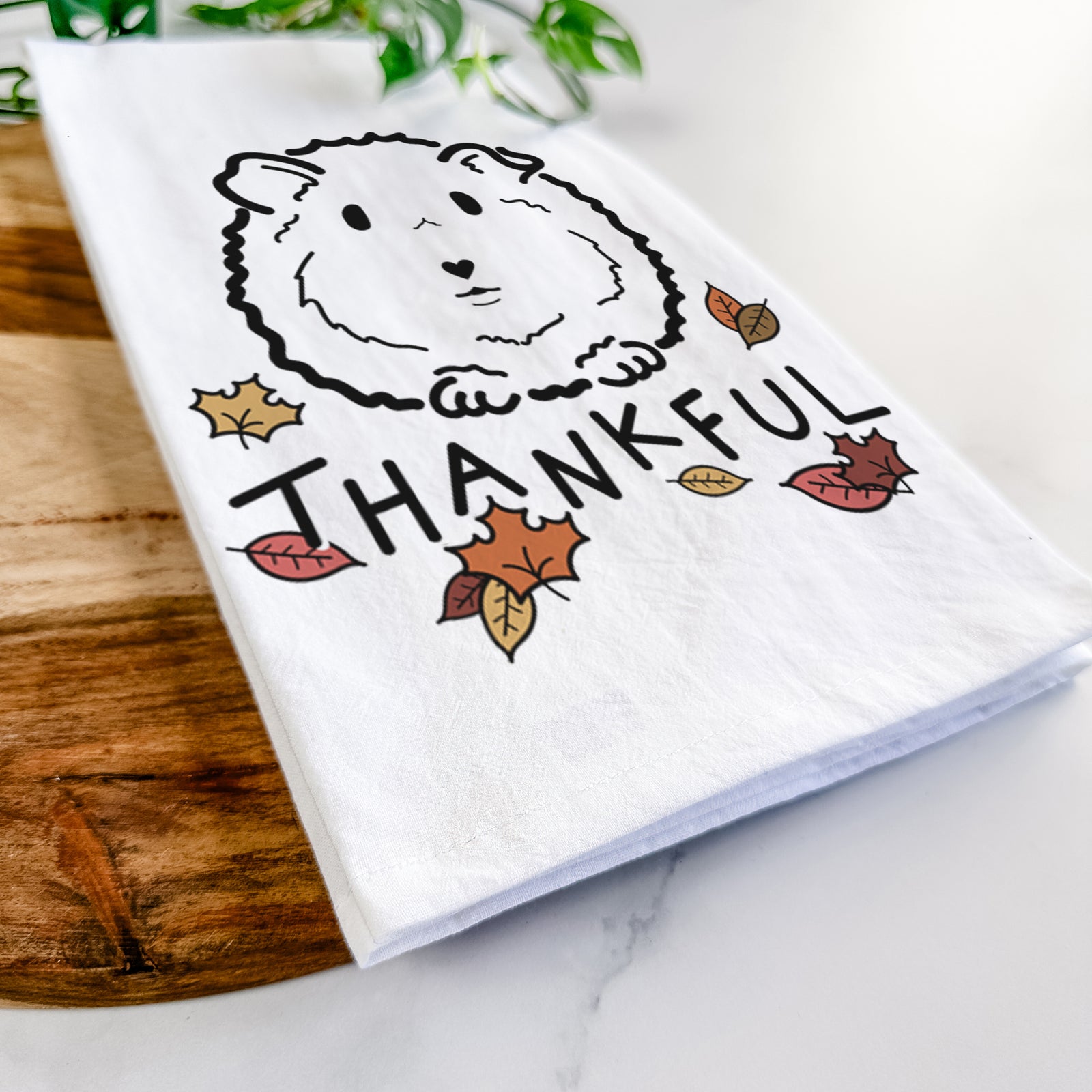 Minimalist line drawing of Duke the Guinea Pig with 'Thankful' lettering on a tea towel