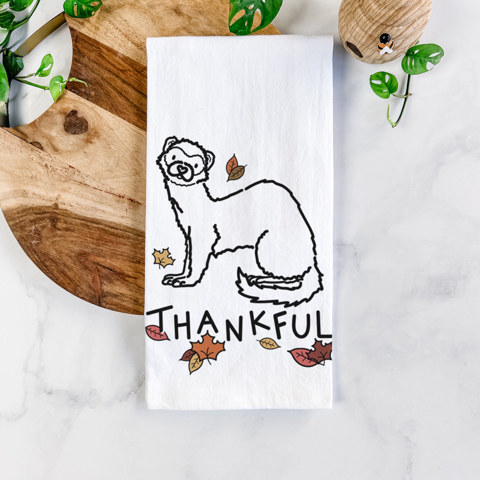 Minimalist line drawing of Fern the Ferret with 'Thankful' lettering on a tea towel