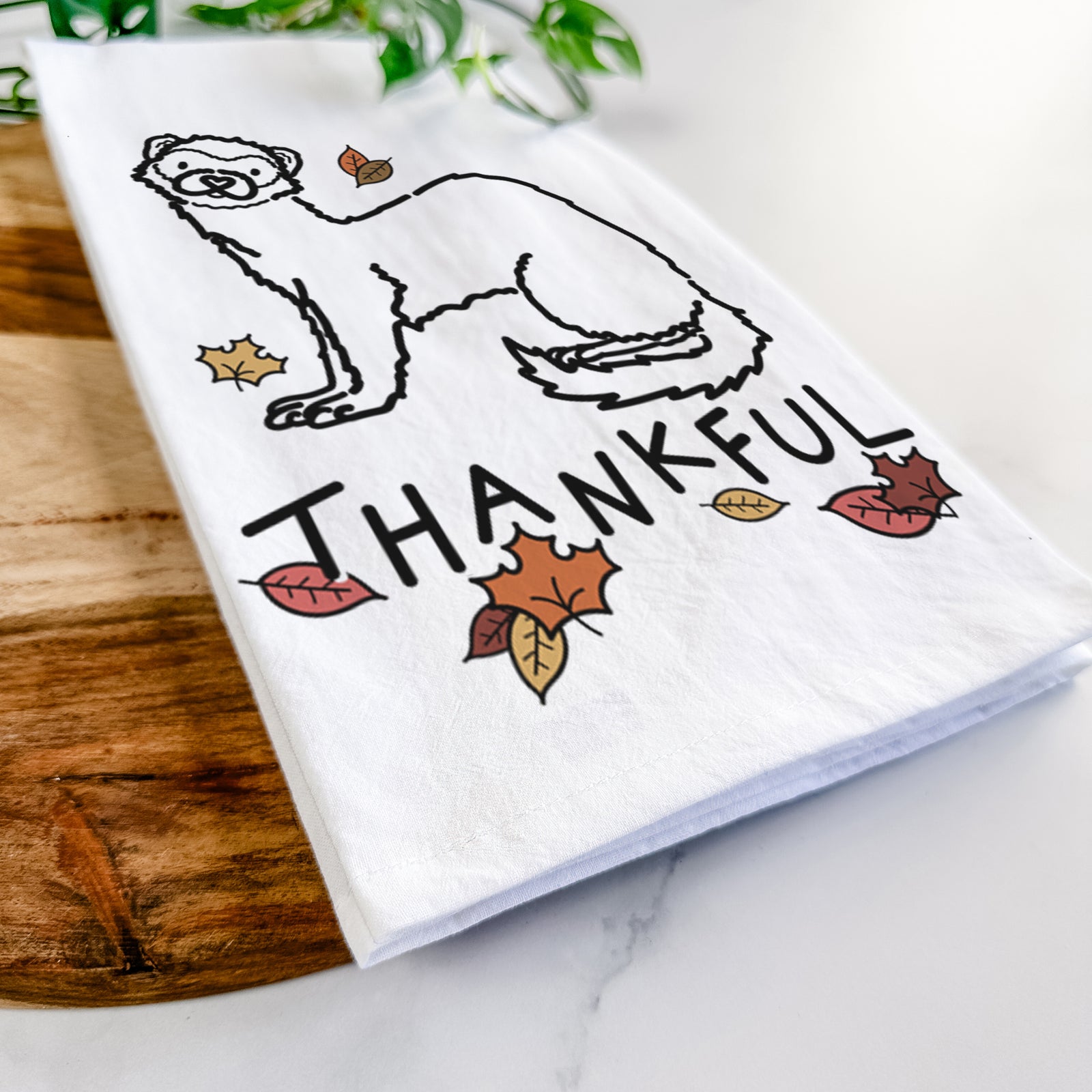 Minimalist line drawing of Fern the Ferret with 'Thankful' lettering on a tea towel