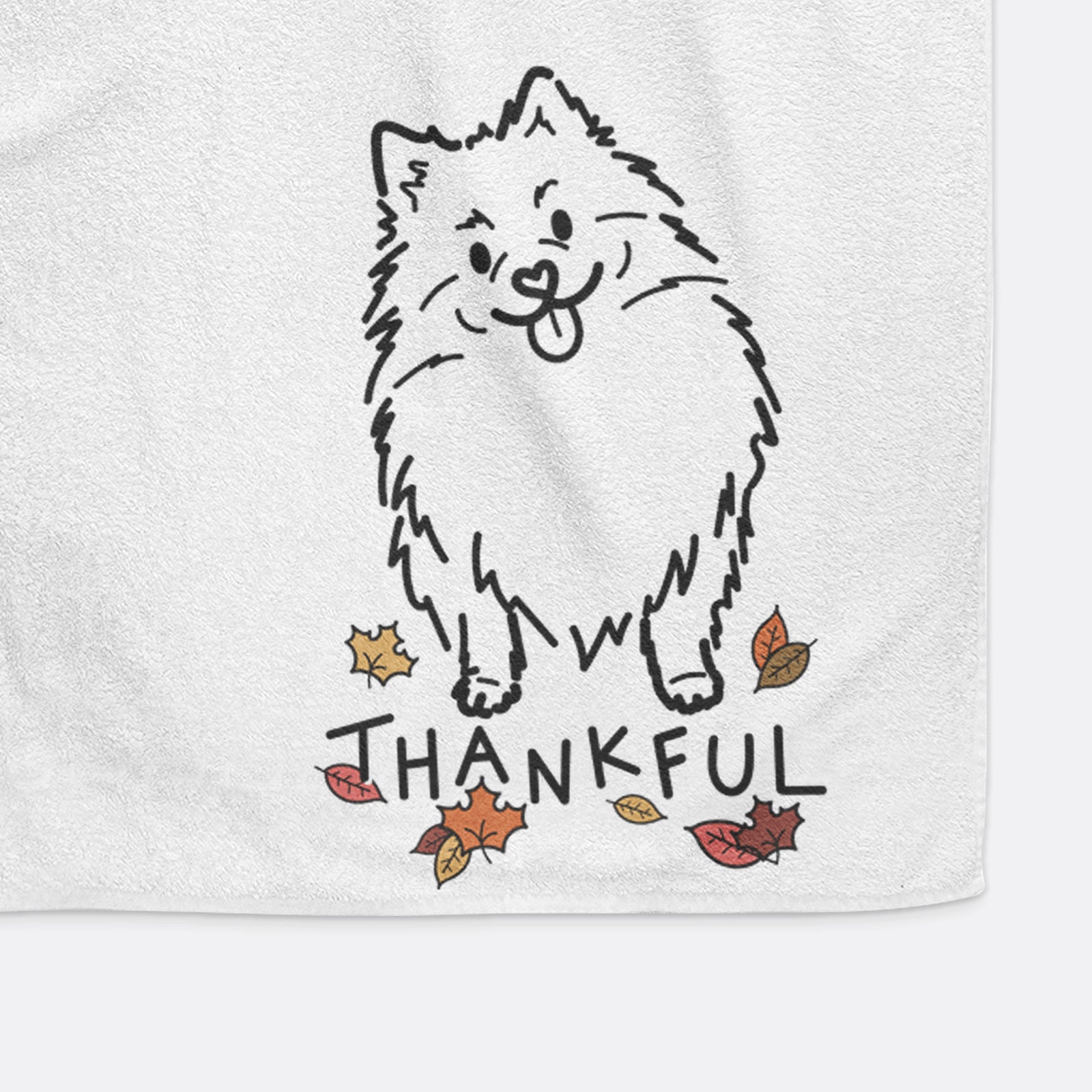 Minimalist line drawing of Fern the Pomeranian with 'Thankful' lettering on a decorative hand towel