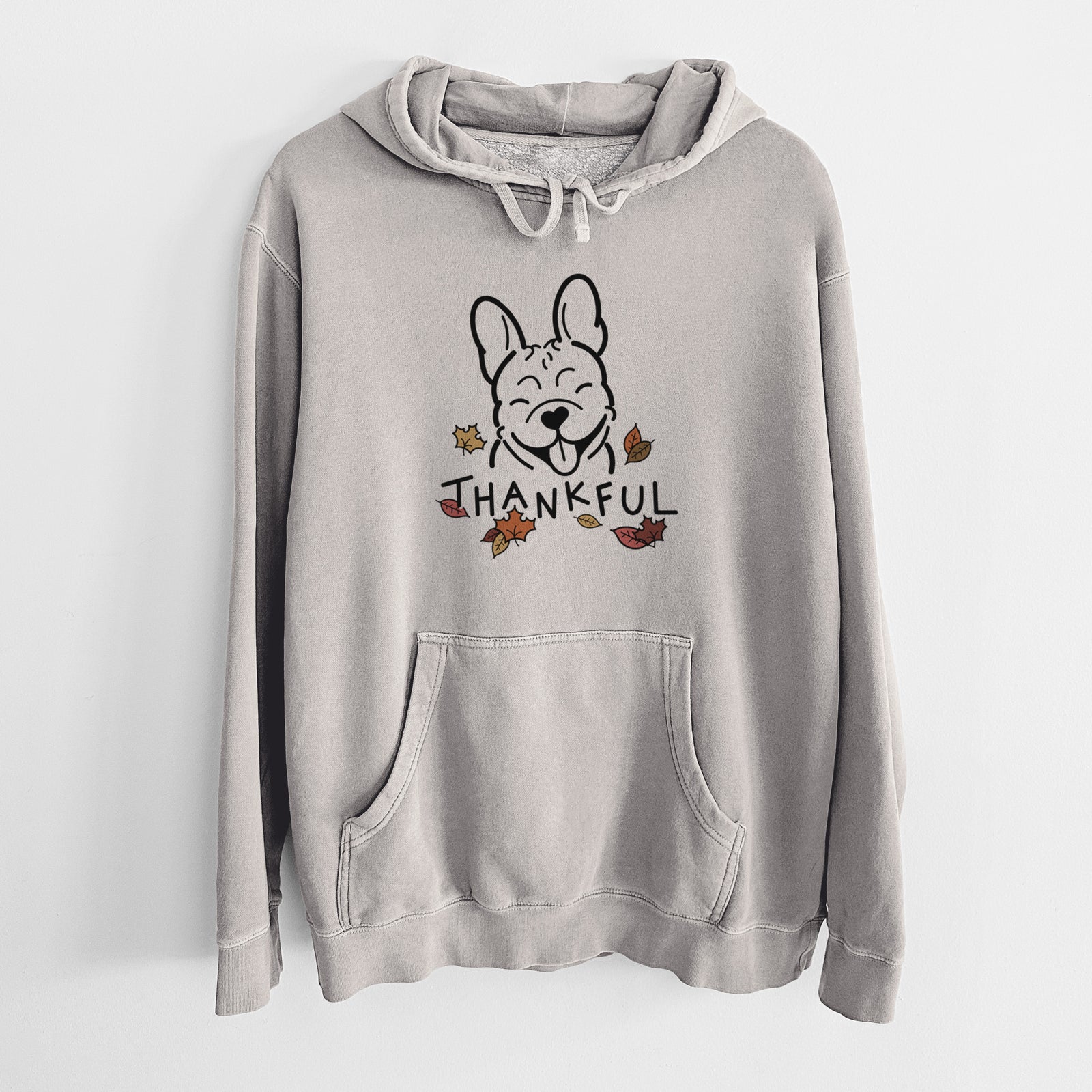 Minimalist line drawing of a French Bulldog with 'Thankful' lettering on a Cement Unisex pigment dyed hoodie
