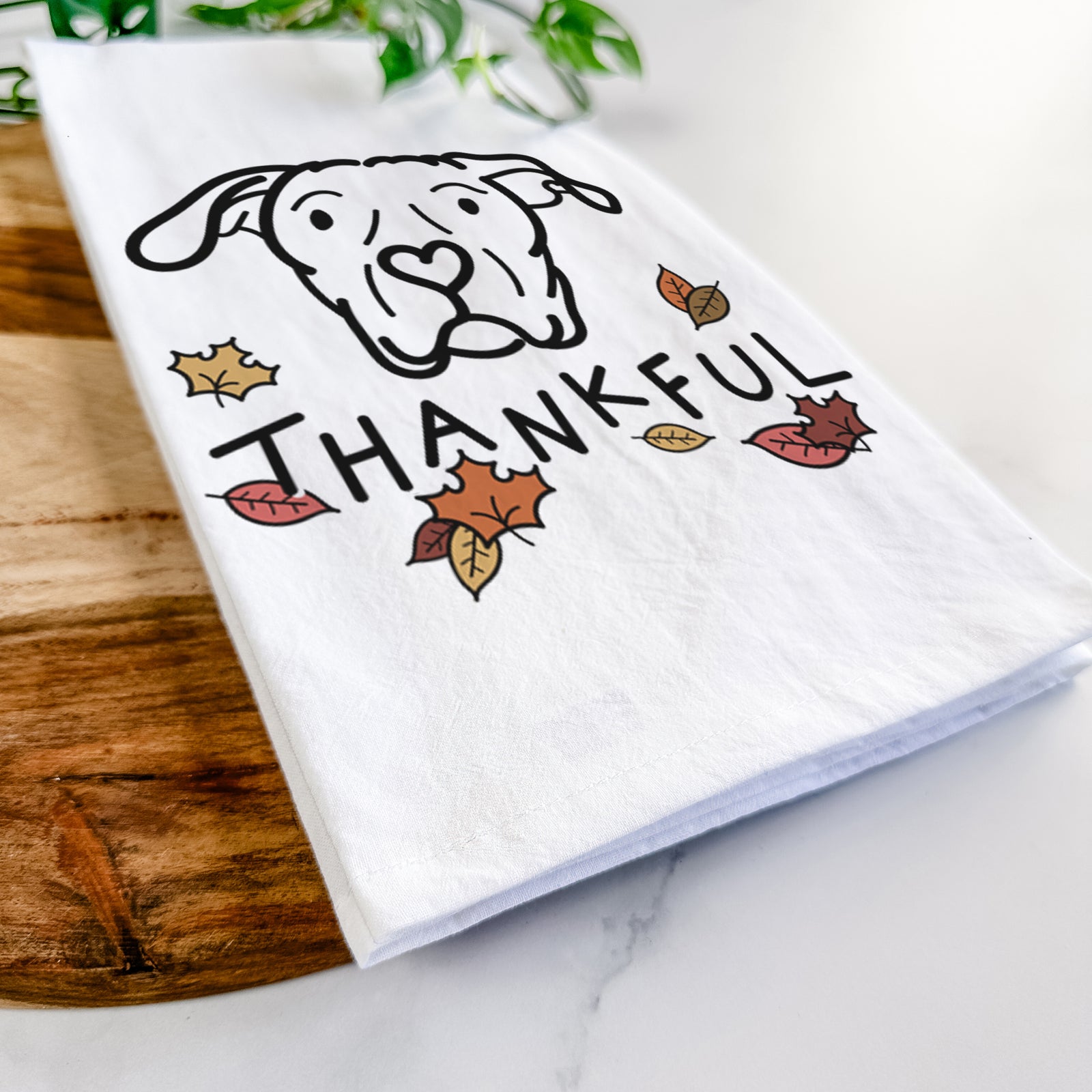 Minimalist line drawing of Genevieve the Dogo Argentino with 'Thankful' lettering on a tea towel